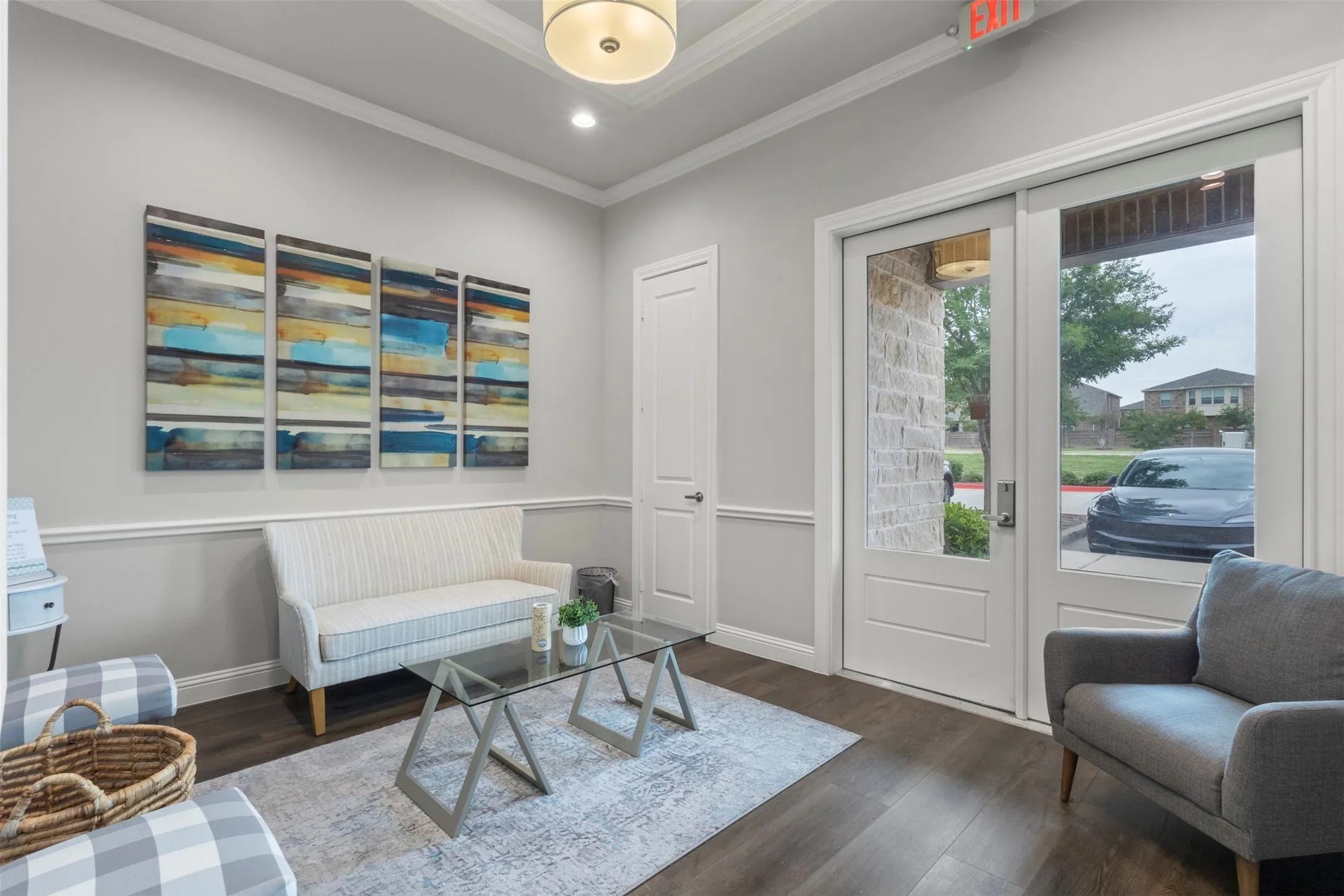Bright entry or common area featuring wood-finish flooring and crown molding