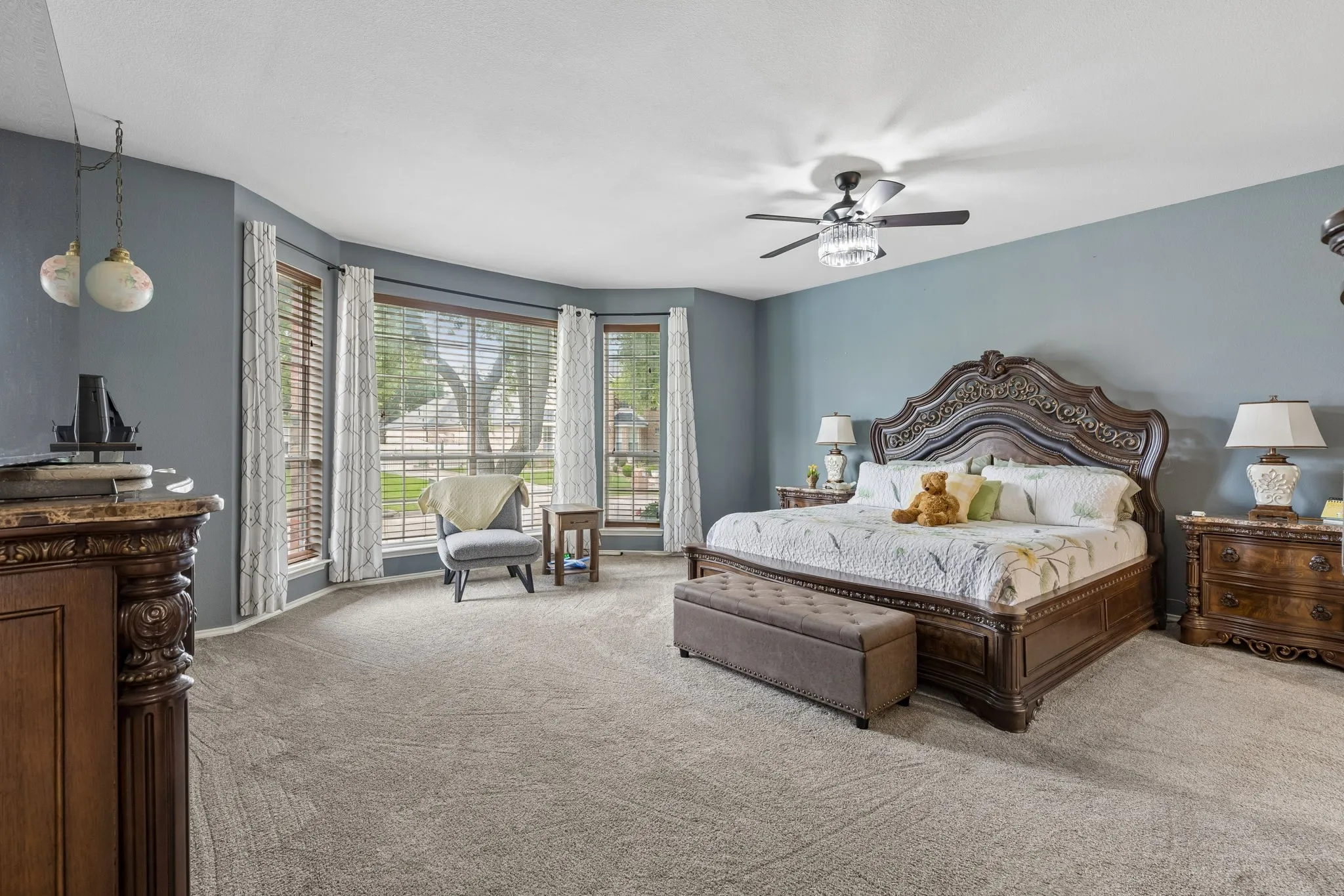 Spacious primary bedroom featuring ceiling fan with integrated lighting