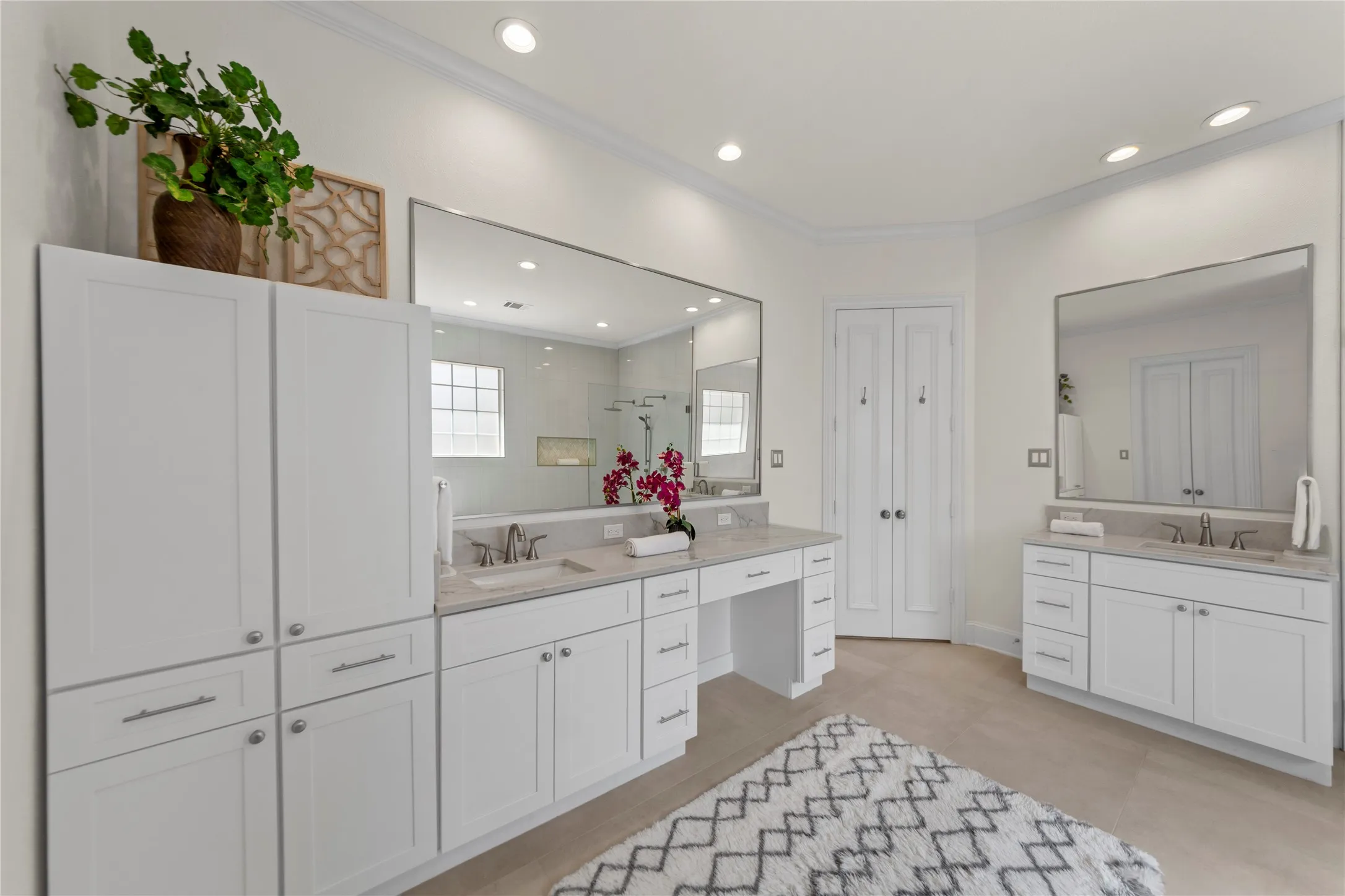 The spacious grand primary suite offers a peaceful retreat with soaring ceilings, abundant natural light, and a beautiful sitting area overlooking the lush backyard and pool. Designed for comfort and relaxation, the oversized bedroom feels bright, airy, and private.The completely updated spa-inspired primary bath showcases new quartz countertops, elegant new tile work, a stunning oversized walk-in shower, and a luxurious new freestanding soaking tub. Dual vanities, modern finishes, fresh designer paint, and thoughtfully selected fixtures create a clean, timeless look with a true resort-style feel. A perfect blend of elegance, comfort, and everyday luxury.