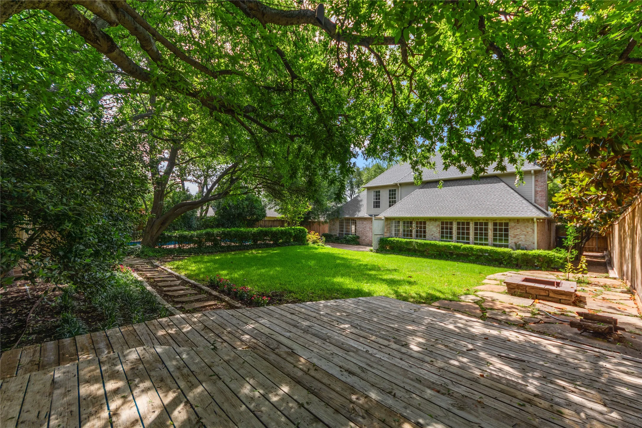 The oversized backyard is a true private retreat, surrounded by mature trees and lush landscaping that create a peaceful, resort-style setting rarely found in Dallas. Enjoy a sparkling pool, expansive patio spaces perfect for entertaining, and an additional large grassy yard with a charming deck area — ideal for outdoor gatherings, play, pets, or simply relaxing under the trees.With multiple outdoor living spaces, this home offers the perfect blend of privacy, nature, and functionality, creating an exceptional indoor-outdoor lifestyle.