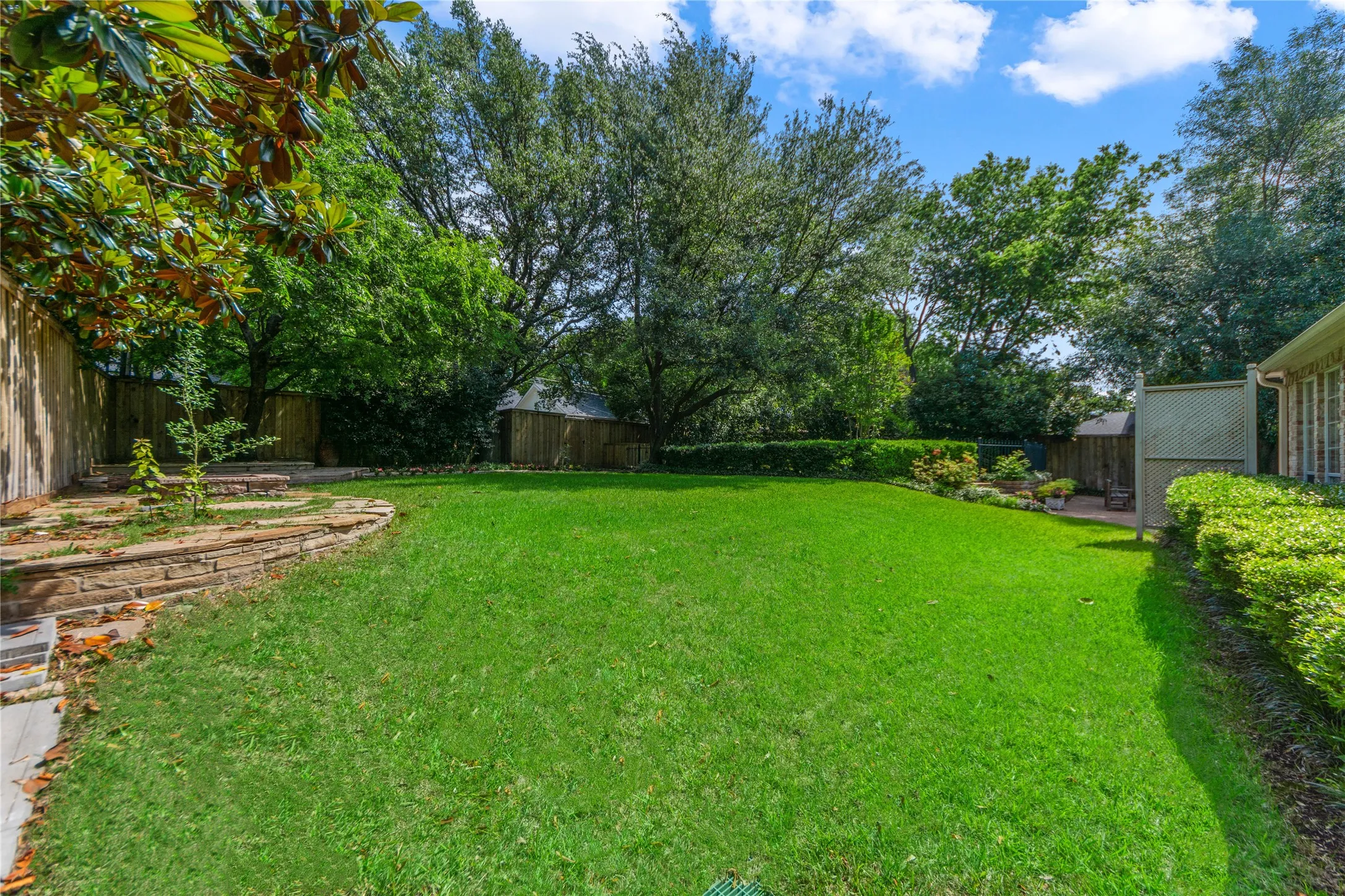 The oversized backyard is a true private retreat, surrounded by mature trees and lush landscaping that create a peaceful, resort-style setting rarely found in Dallas. Enjoy a sparkling pool, expansive patio spaces perfect for entertaining, and an additional large grassy yard with a charming deck area — ideal for outdoor gatherings, play, pets, or simply relaxing under the trees.With multiple outdoor living spaces, this home offers the perfect blend of privacy, nature, and functionality, creating an exceptional indoor-outdoor lifestyle.