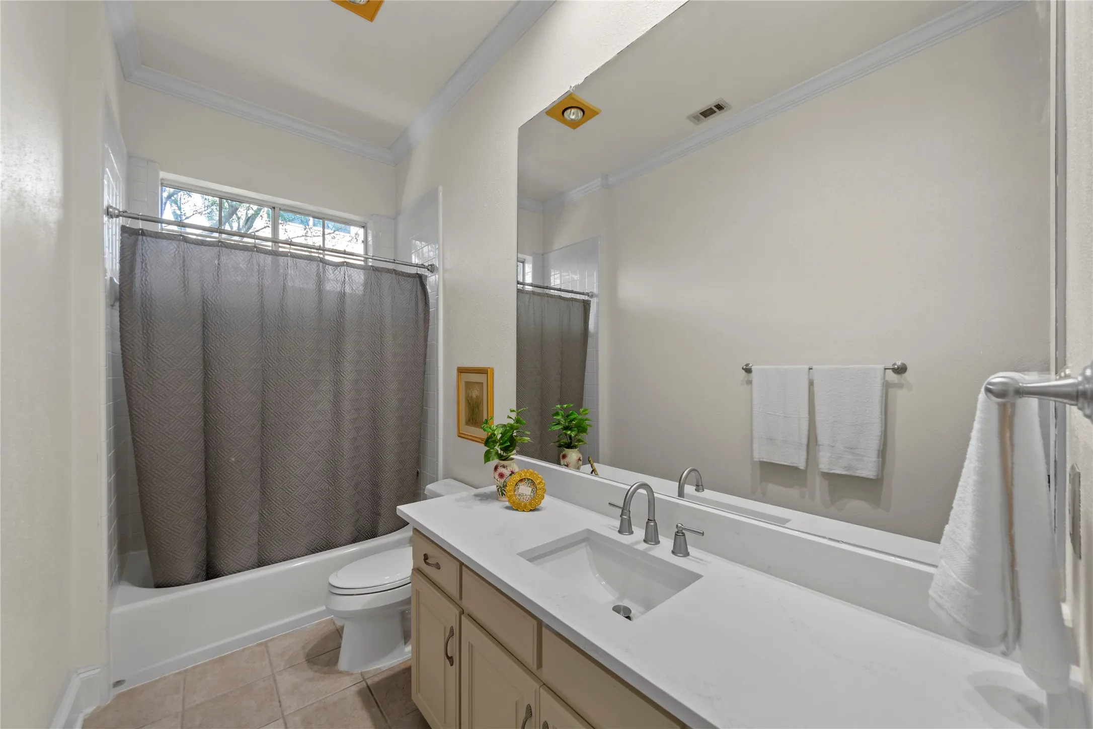 The beautifully updated Jack-and-Jill bathroom features new quartz countertops, stylish new flooring, updated fixtures, and fresh modern finishes that create a clean and timeless look. The functional shared layout offers both convenience and comfort while maintaining an elegant, updated design throughout the upstairs living spaces.