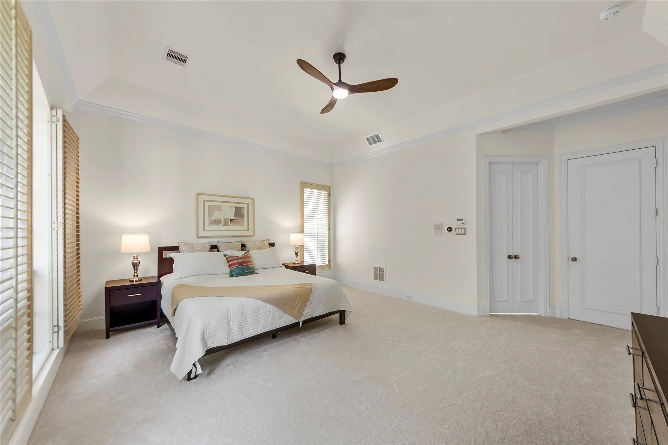 The spacious grand primary suite offers a peaceful retreat with soaring ceilings, abundant natural light, and a beautiful sitting area overlooking the lush backyard and pool. Designed for comfort and relaxation, the oversized bedroom feels bright, airy, and private.The completely updated spa-inspired primary bath showcases new quartz countertops, elegant new tile work, a stunning oversized walk-in shower, and a luxurious new freestanding soaking tub. Dual vanities, modern finishes, fresh designer paint, and thoughtfully selected fixtures create a clean, timeless look with a true resort-style feel. A perfect blend of elegance, comfort, and everyday luxury.