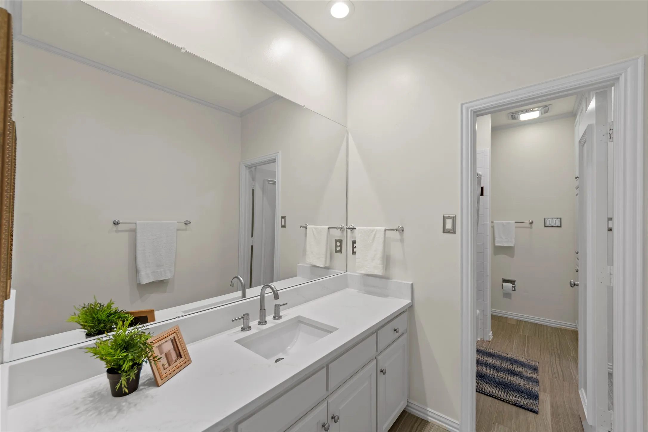 The beautifully updated Jack-and-Jill bathroom features new quartz countertops, stylish new flooring, updated fixtures, and fresh modern finishes that create a clean and timeless look. The functional shared layout offers both convenience and comfort while maintaining an elegant, updated design throughout the upstairs living spaces.