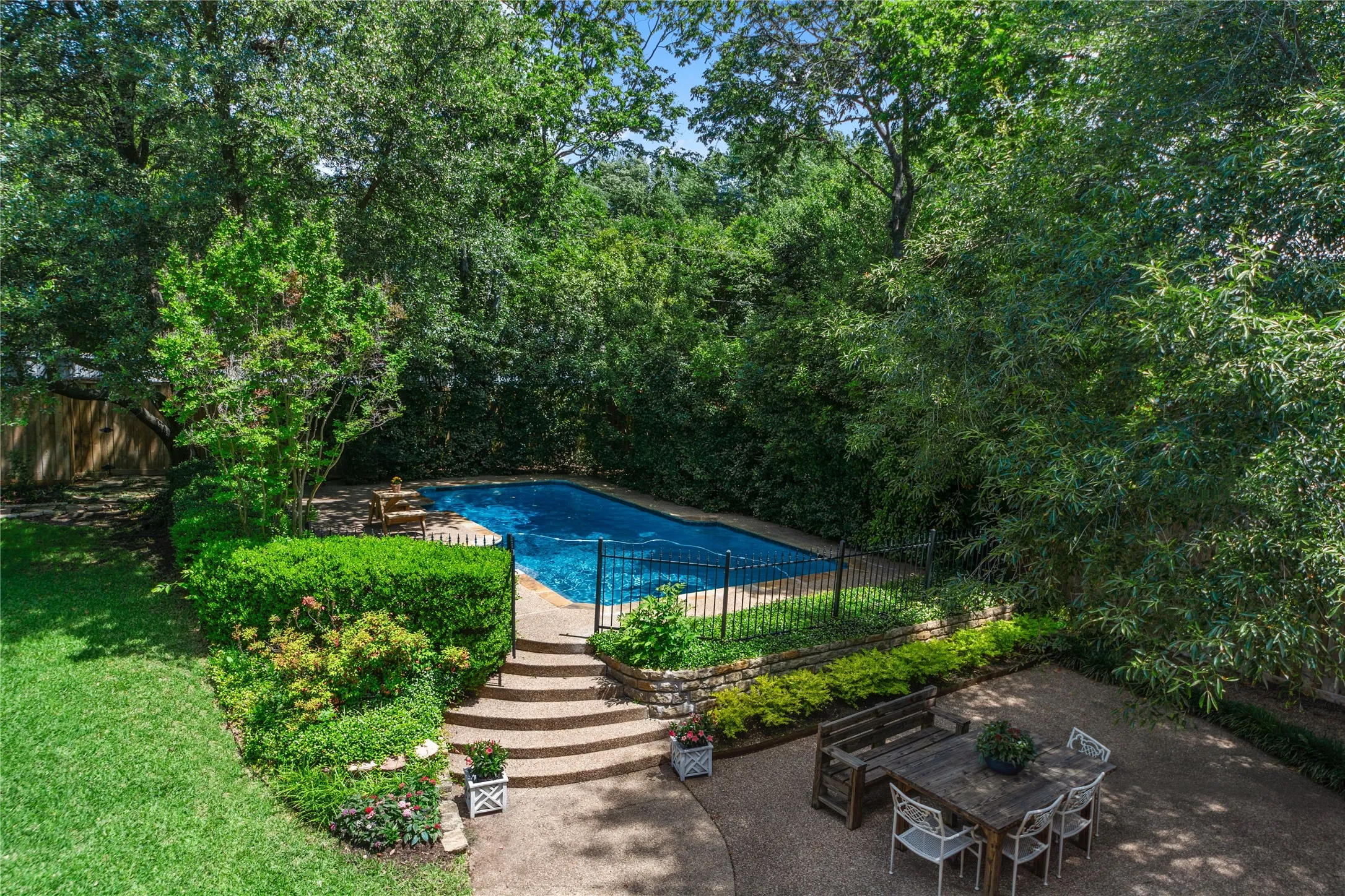 The oversized backyard is a true private retreat, surrounded by mature trees and lush landscaping that create a peaceful, resort-style setting rarely found in Dallas. Enjoy a sparkling pool, expansive patio spaces perfect for entertaining, and an additional large grassy yard with a charming deck area — ideal for outdoor gatherings, play, pets, or simply relaxing under the trees.With multiple outdoor living spaces, this home offers the perfect blend of privacy, nature, and functionality, creating an exceptional indoor-outdoor lifestyle.