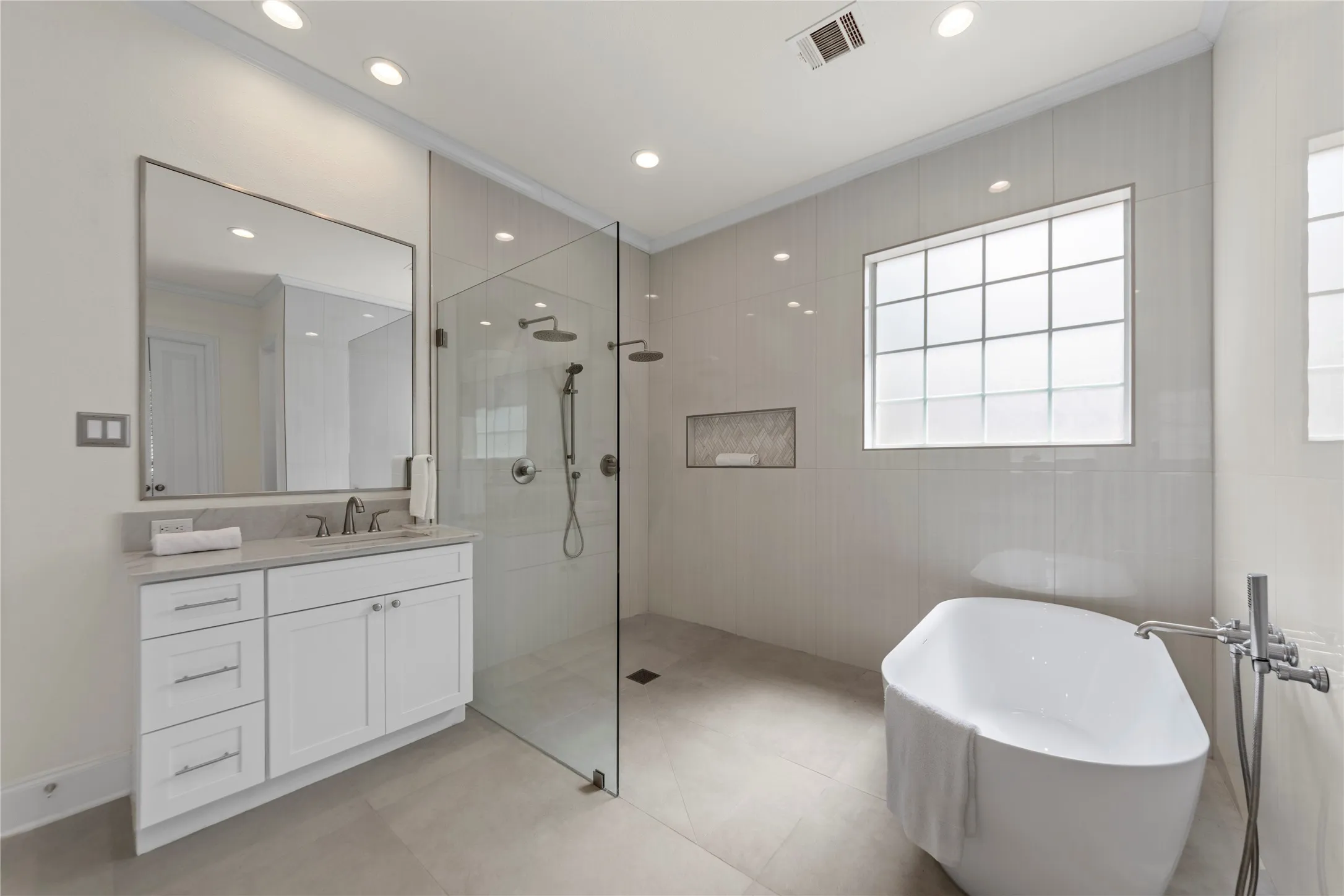 The spacious grand primary suite offers a peaceful retreat with soaring ceilings, abundant natural light, and a beautiful sitting area overlooking the lush backyard and pool. Designed for comfort and relaxation, the oversized bedroom feels bright, airy, and private.The completely updated spa-inspired primary bath showcases new quartz countertops, elegant new tile work, a stunning oversized walk-in shower, and a luxurious new freestanding soaking tub. Dual vanities, modern finishes, fresh designer paint, and thoughtfully selected fixtures create a clean, timeless look with a true resort-style feel. A perfect blend of elegance, comfort, and everyday luxury.