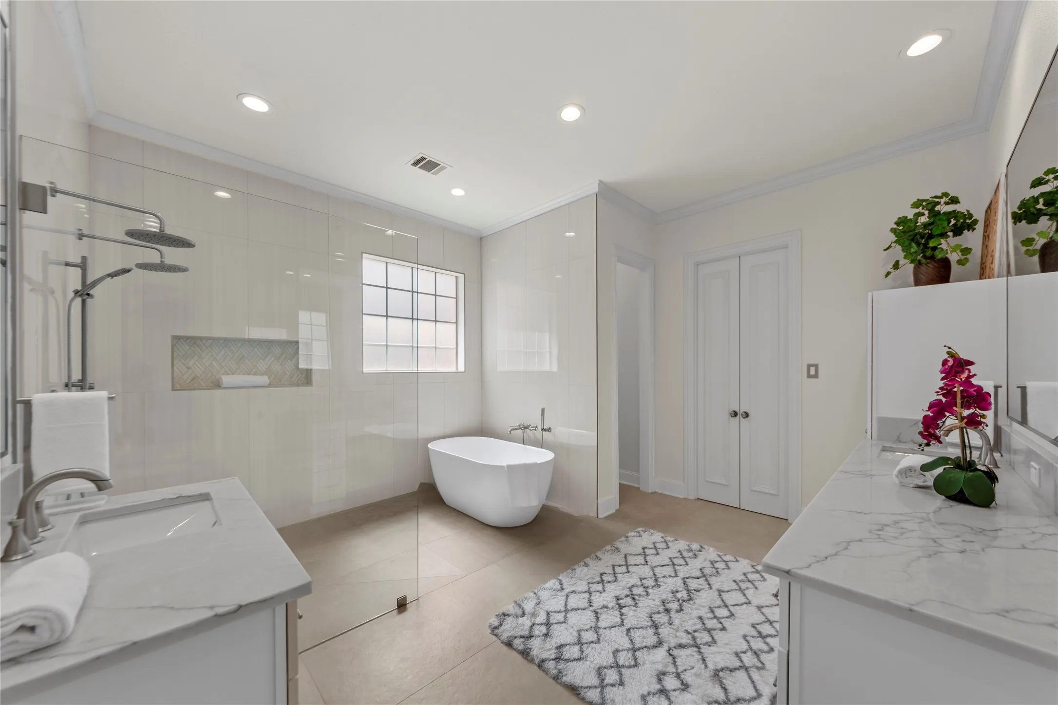 The spacious grand primary suite offers a peaceful retreat with soaring ceilings, abundant natural light, and a beautiful sitting area overlooking the lush backyard and pool. Designed for comfort and relaxation, the oversized bedroom feels bright, airy, and private.The completely updated spa-inspired primary bath showcases new quartz countertops, elegant new tile work, a stunning oversized walk-in shower, and a luxurious new freestanding soaking tub. Dual vanities, modern finishes, fresh designer paint, and thoughtfully selected fixtures create a clean, timeless look with a true resort-style feel. A perfect blend of elegance, comfort, and everyday luxury.