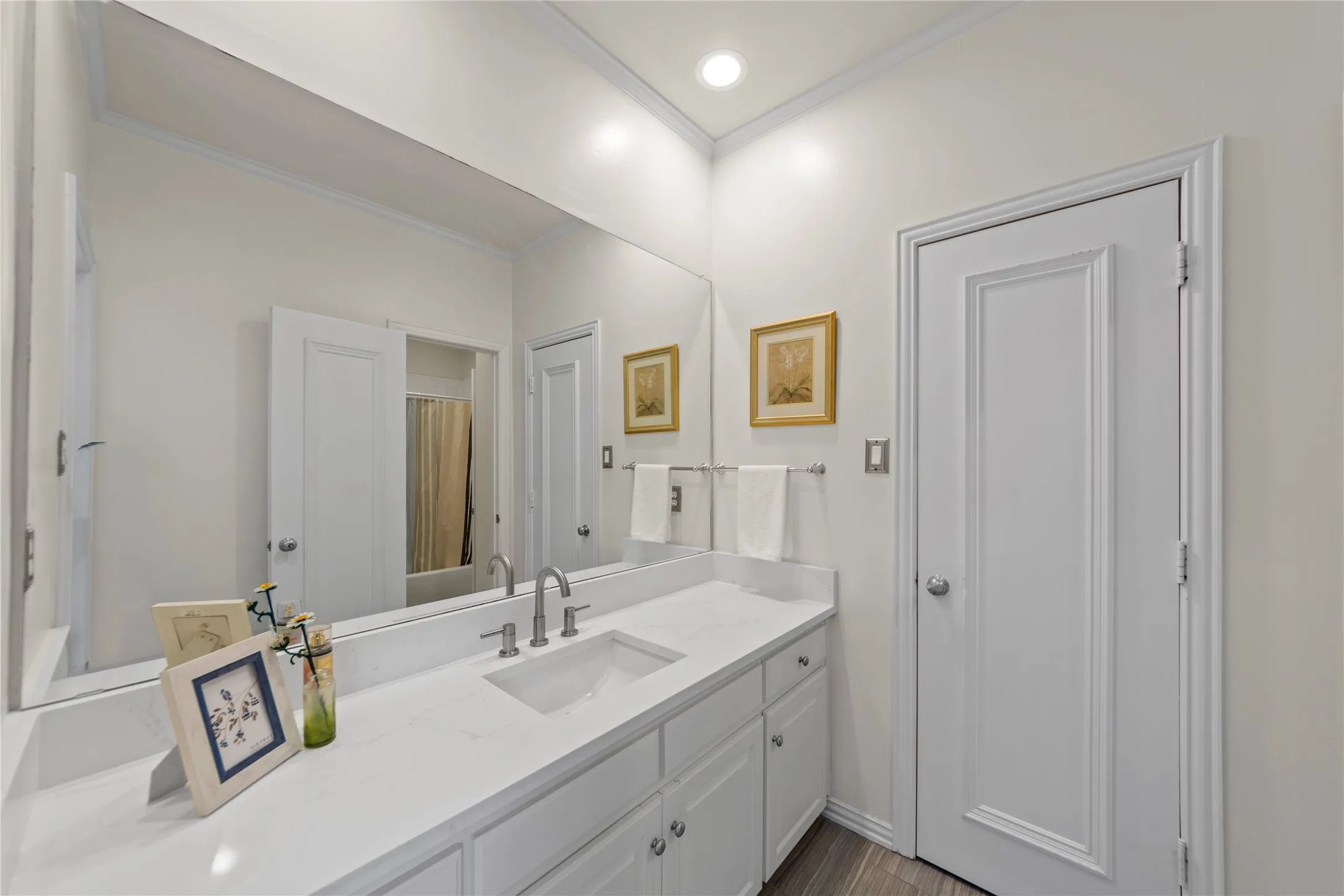 The beautifully updated Jack-and-Jill bathroom features new quartz countertops, stylish new flooring, updated fixtures, and fresh modern finishes that create a clean and timeless look. The functional shared layout offers both convenience and comfort while maintaining an elegant, updated design throughout the upstairs living spaces.