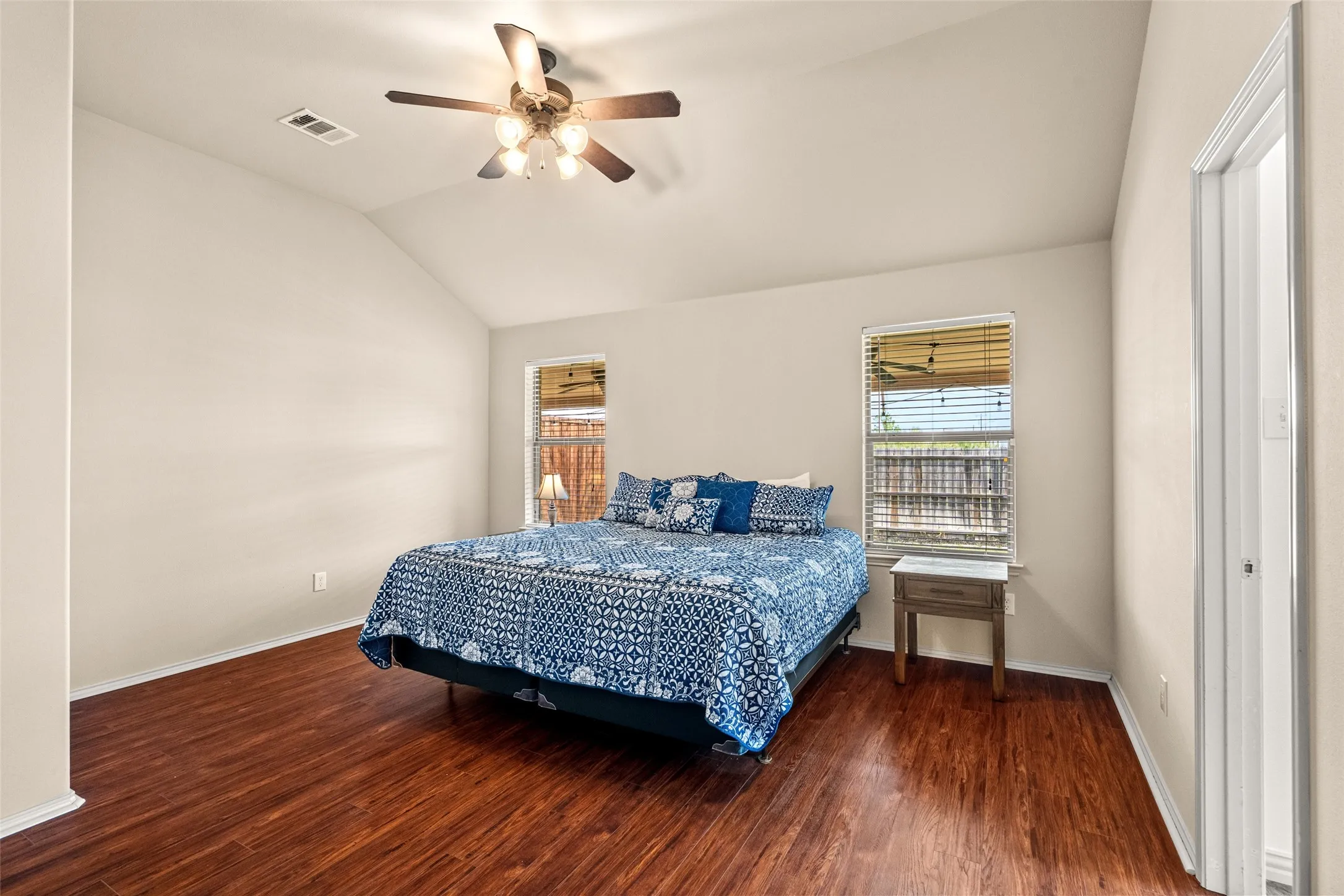 Interior space featuring vaulted ceilings, wood-finish flooring, and recessed lighting