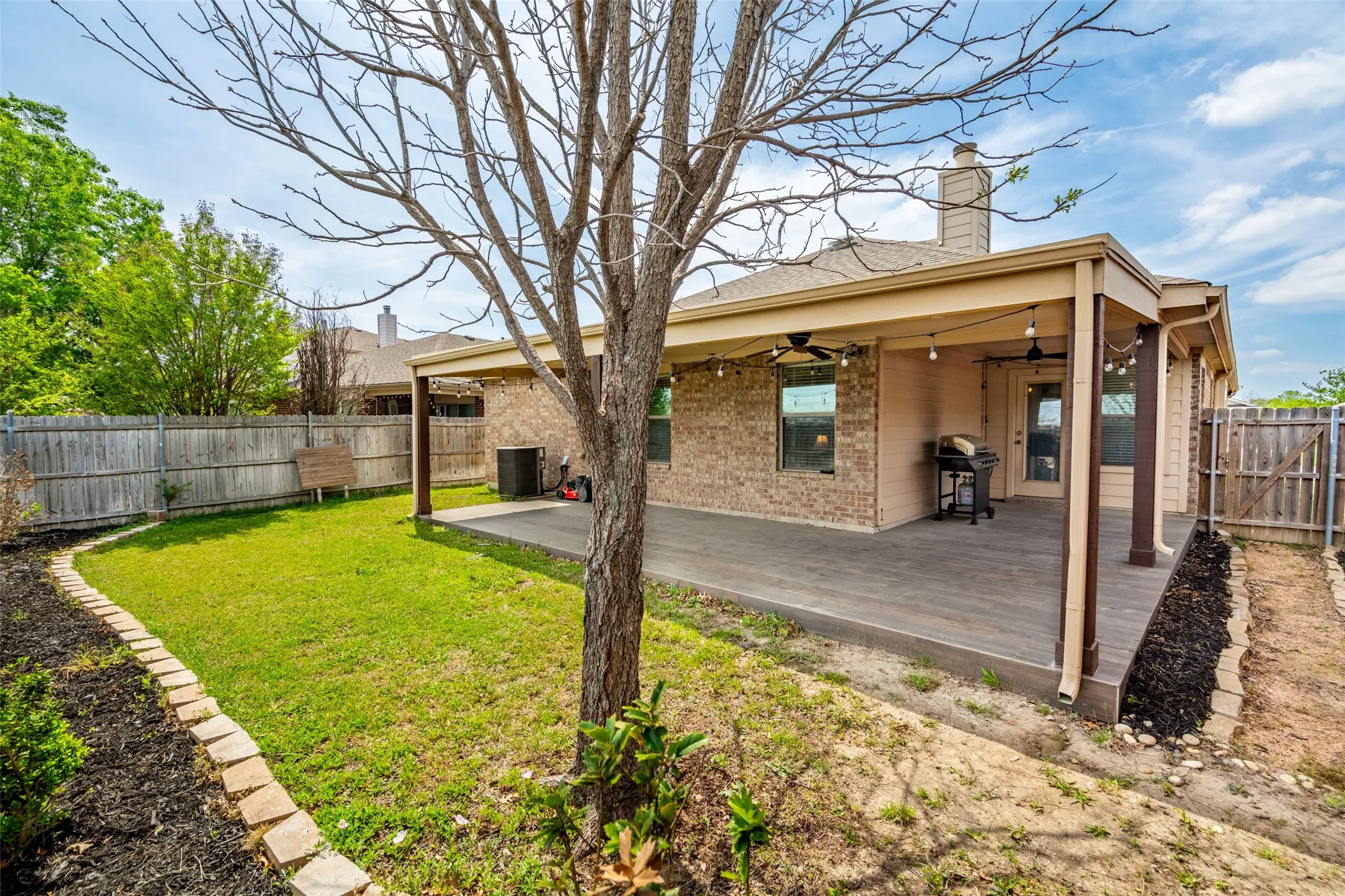 Covered patio with integrated string lighting and ceiling fans