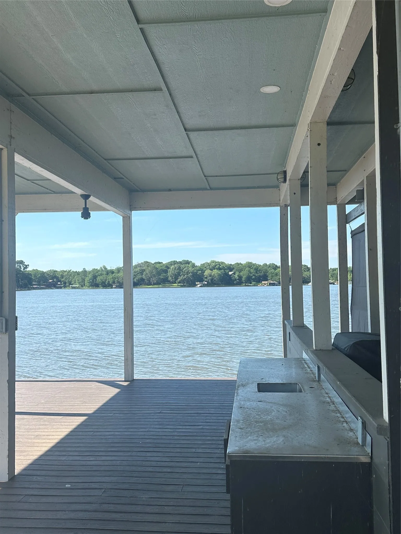 Dock area featuring boat lift and a water view