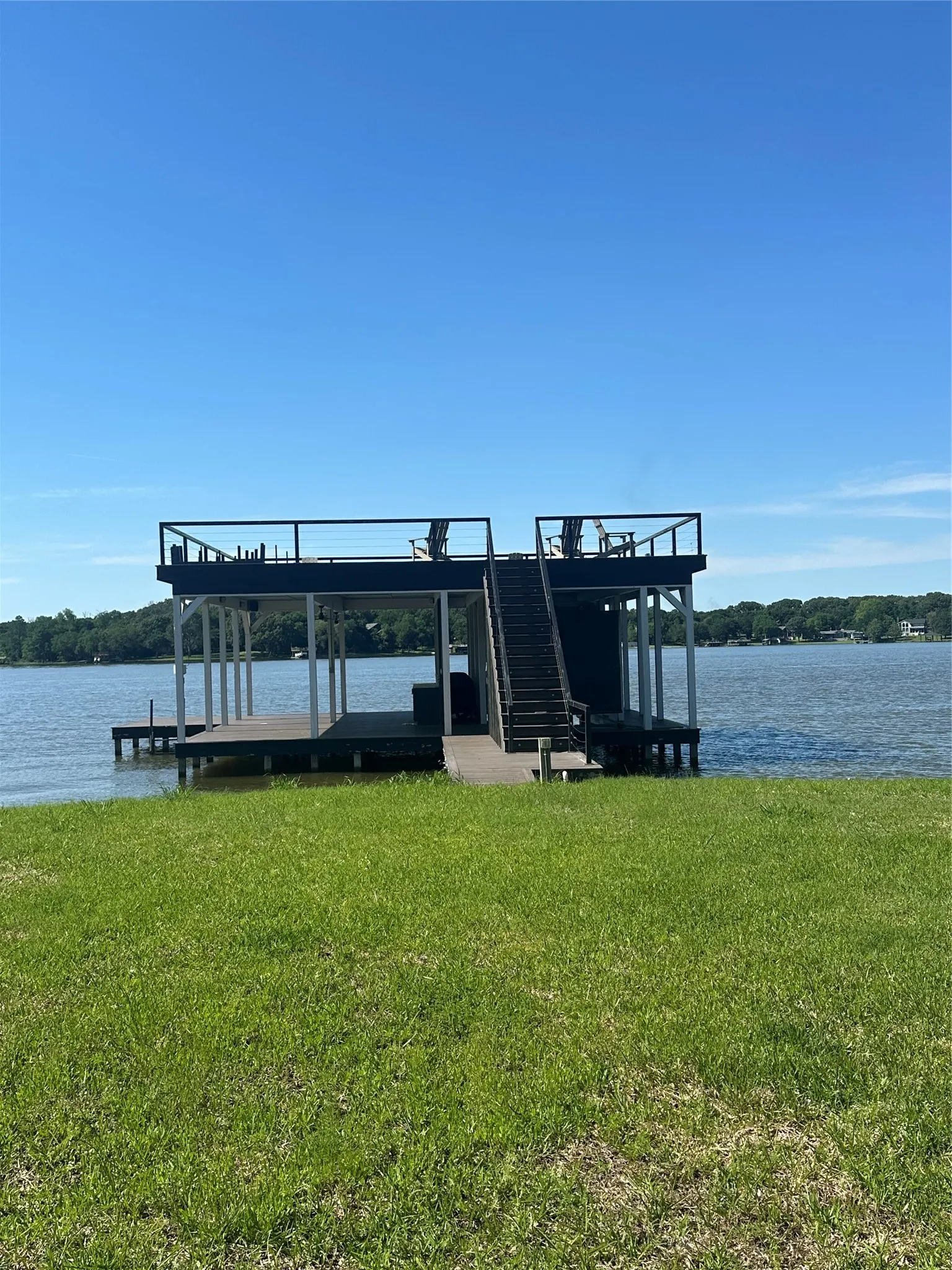 Dock area with a yard, a water view, and boat lift