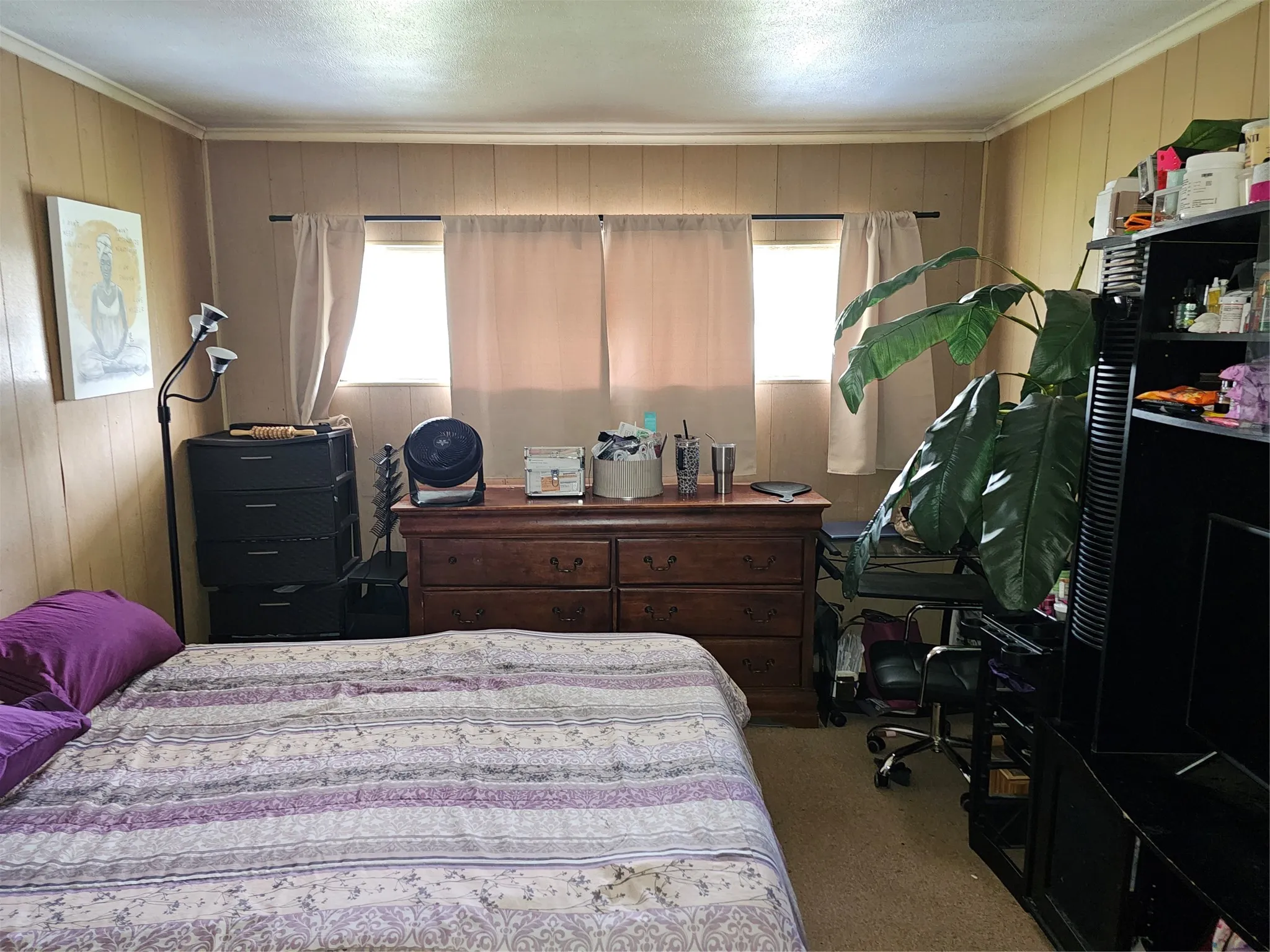 Room featuring light wood paneling, carpeted flooring, and crown molding
