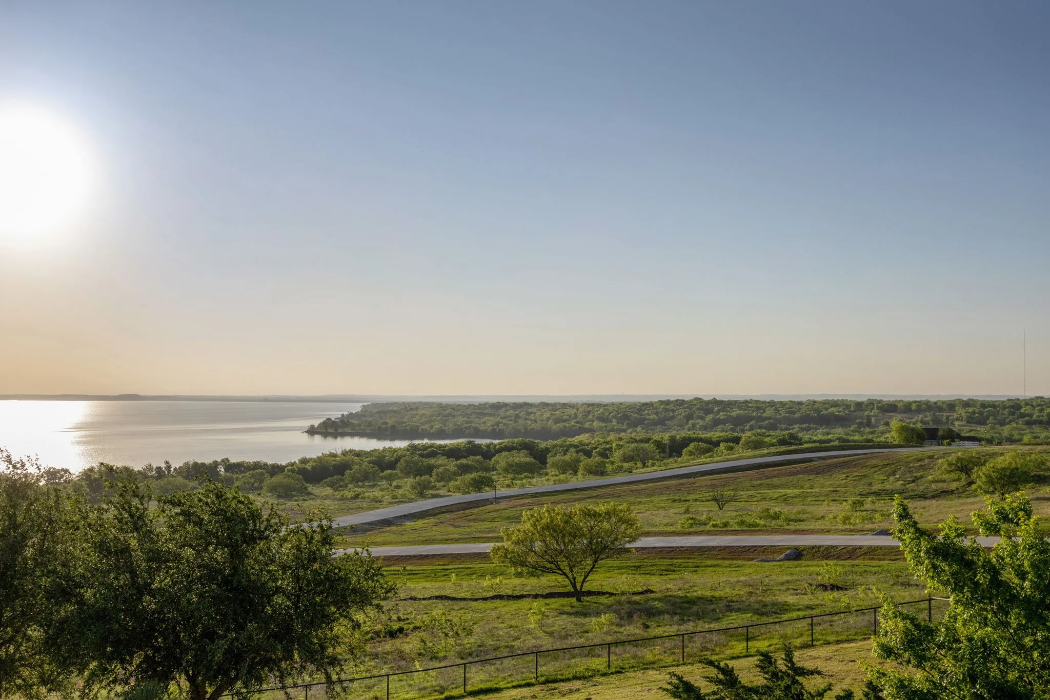 Expansive water frontage with a tree-lined shore and distant landmass