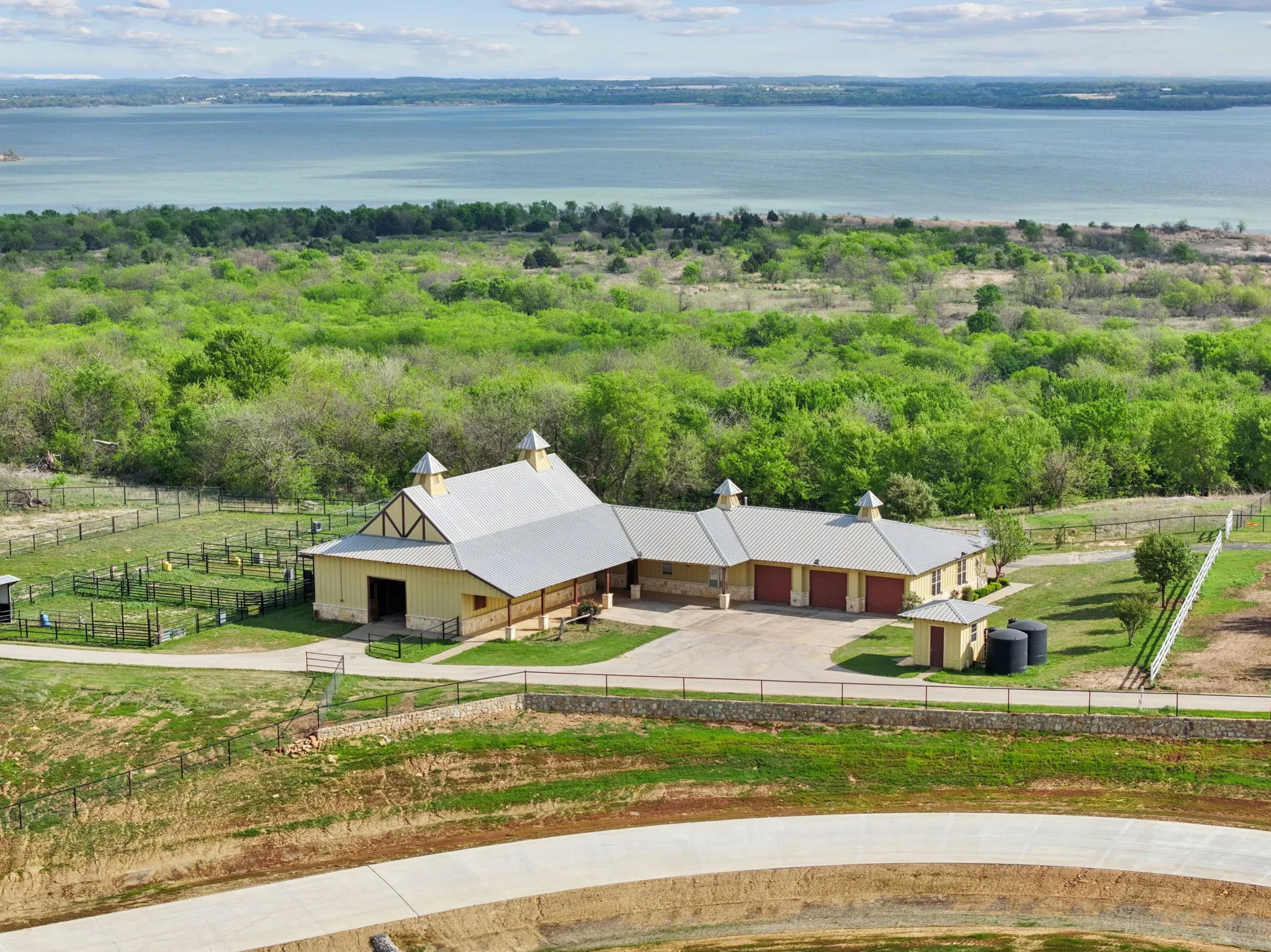 Expansive property featuring a multi-structure complex with a metal roof and cupolas