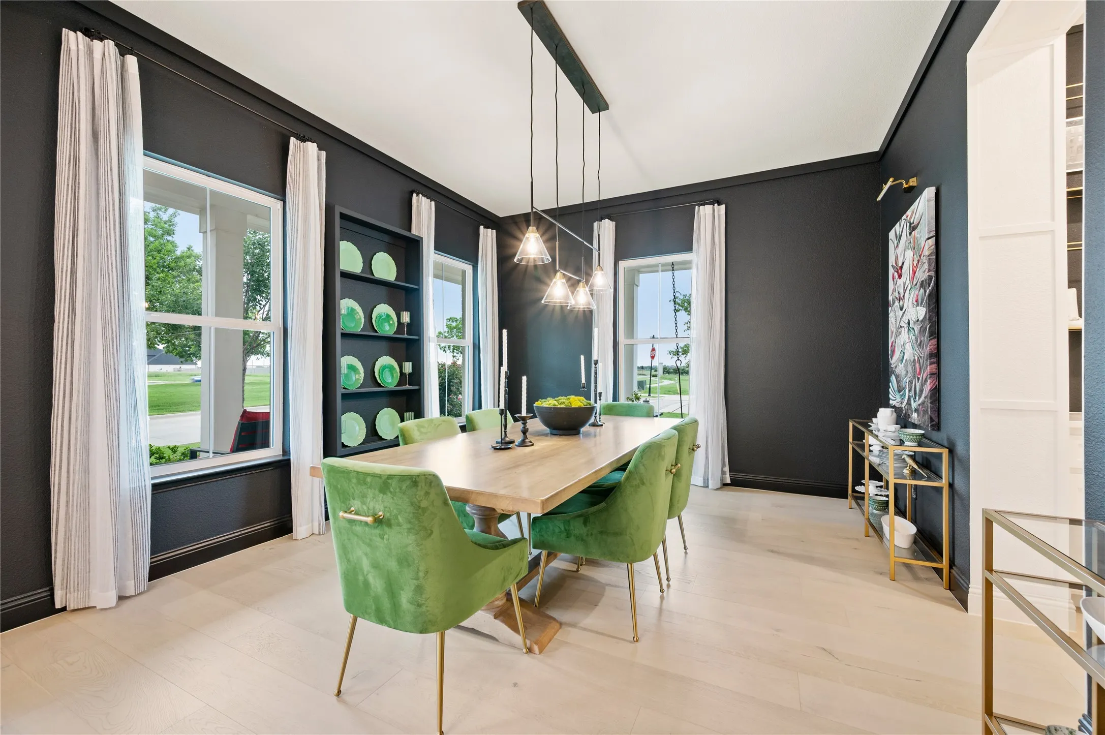 Formal Dining space off the entry, with a wet bar, natural light, wood flooring and custom woodwork.