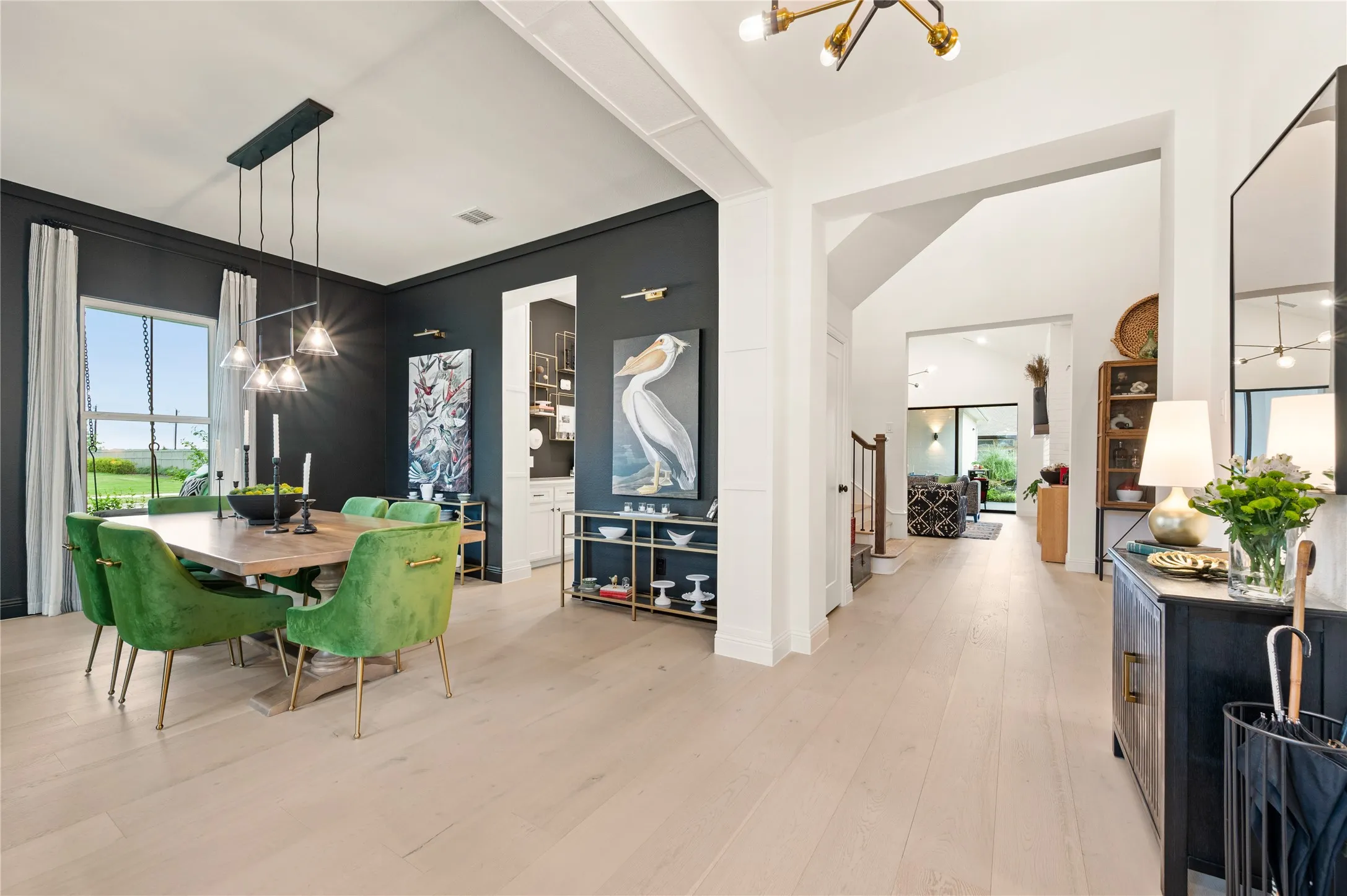 Formal Dining space off the entry, with a wet bar, natural light, wood flooring and custom woodwork.