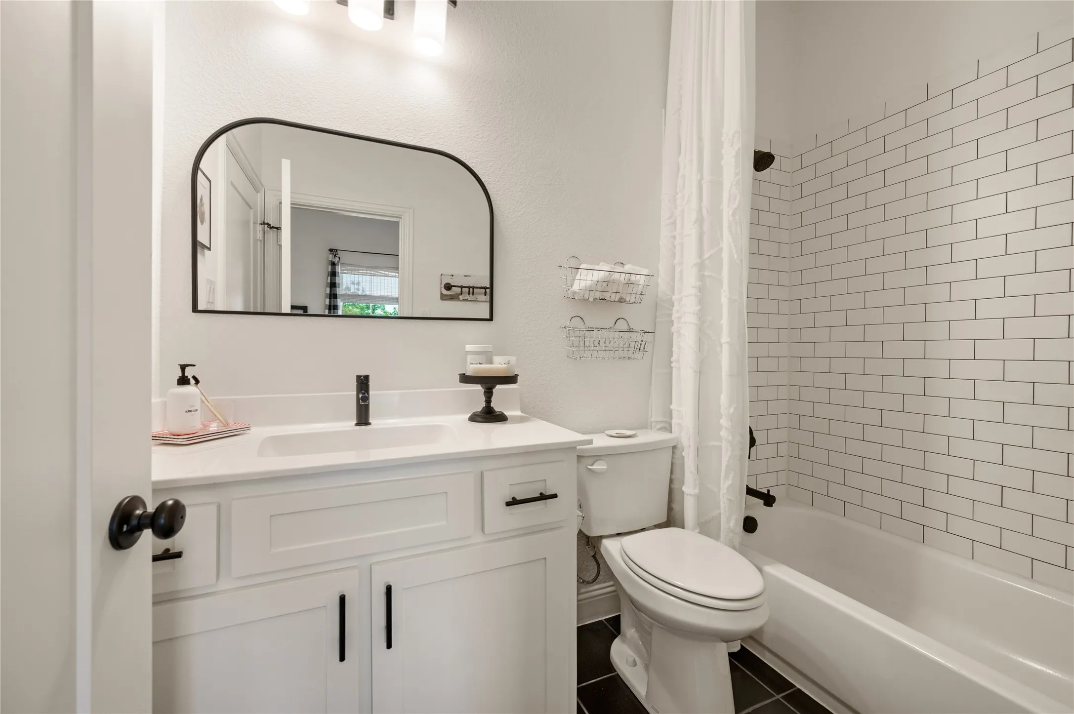 Ensuite bathroom on second level with custom fixtures, hardware and mirror.