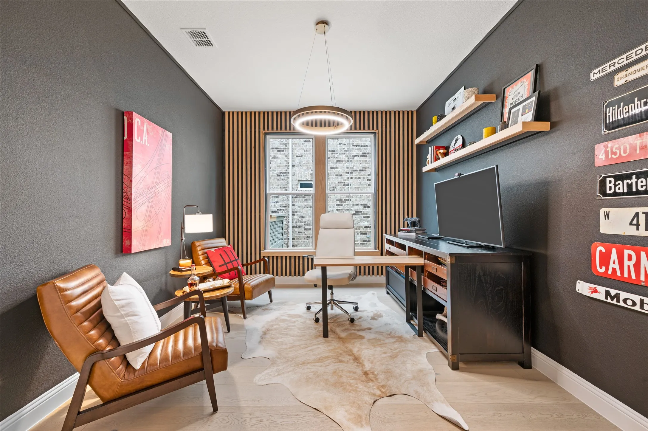 Large office with transom window and custom french doors, custom paint, wall accents and fixtures.