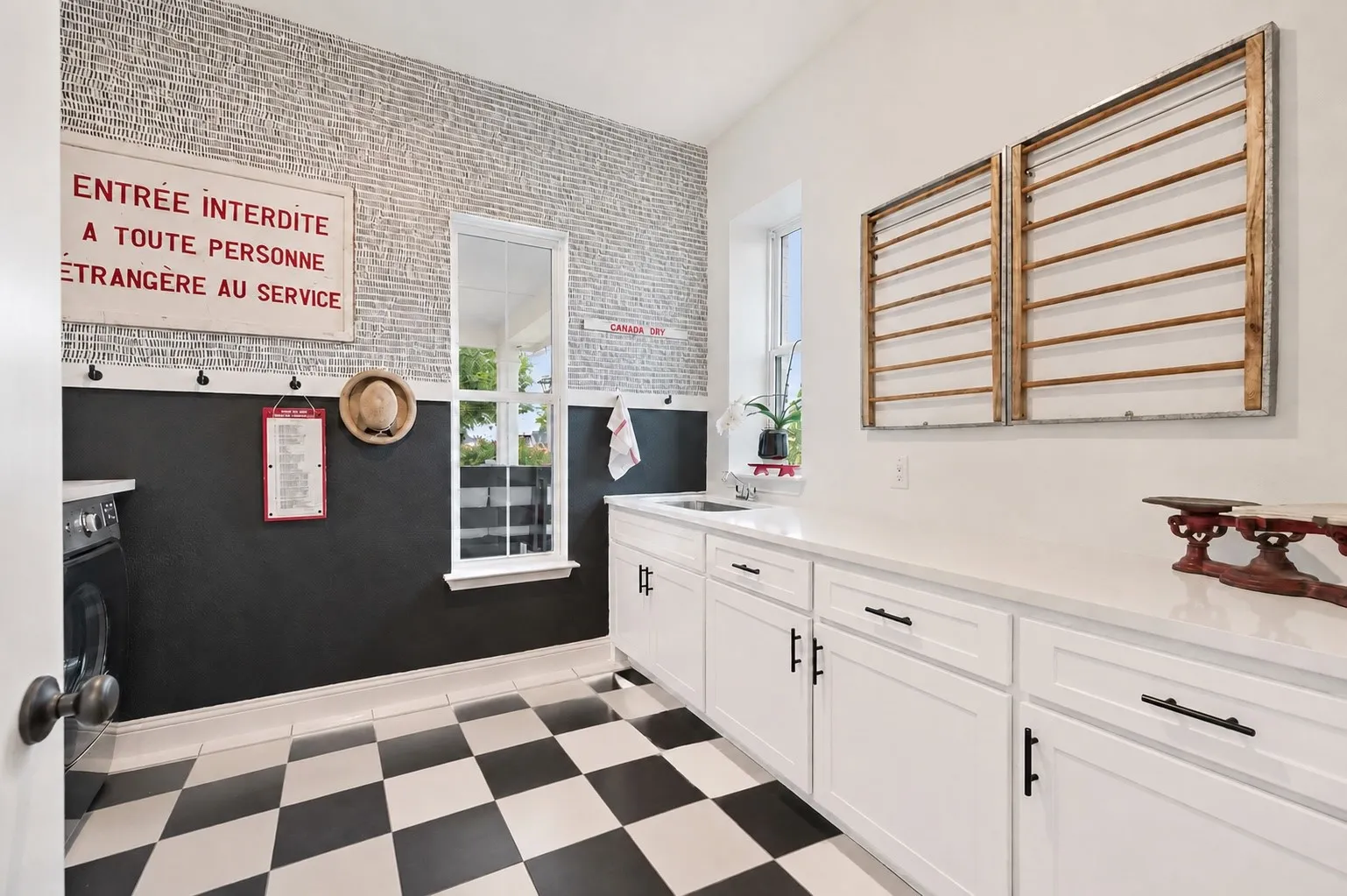 Custom dedicated and expanded laundry room with built in cabinets, tile flooring, utility sink and more
