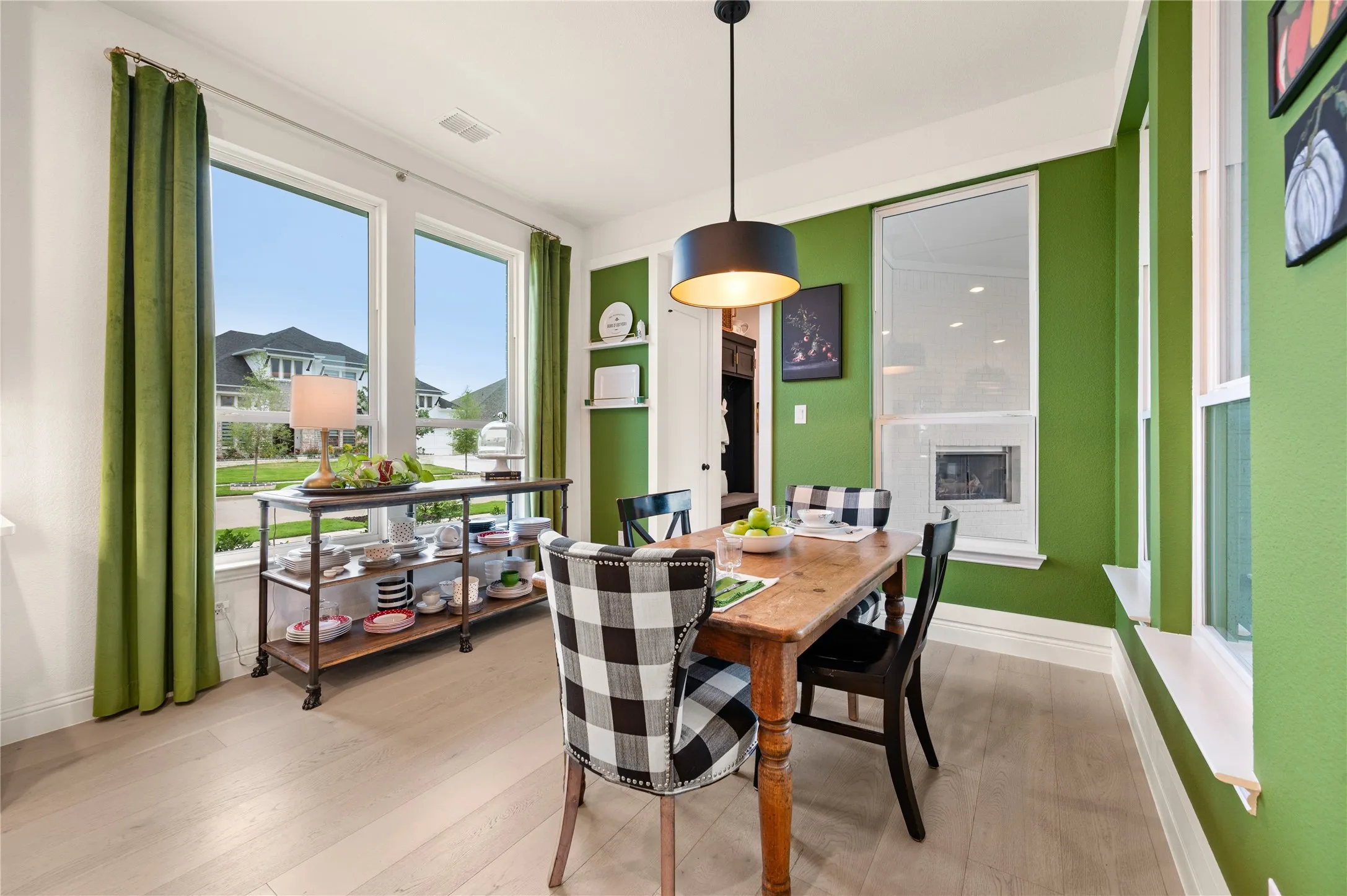 Open-concept kitchen and breakfast area featuring light wood flooring, custom paint, fixtures, hardware and more