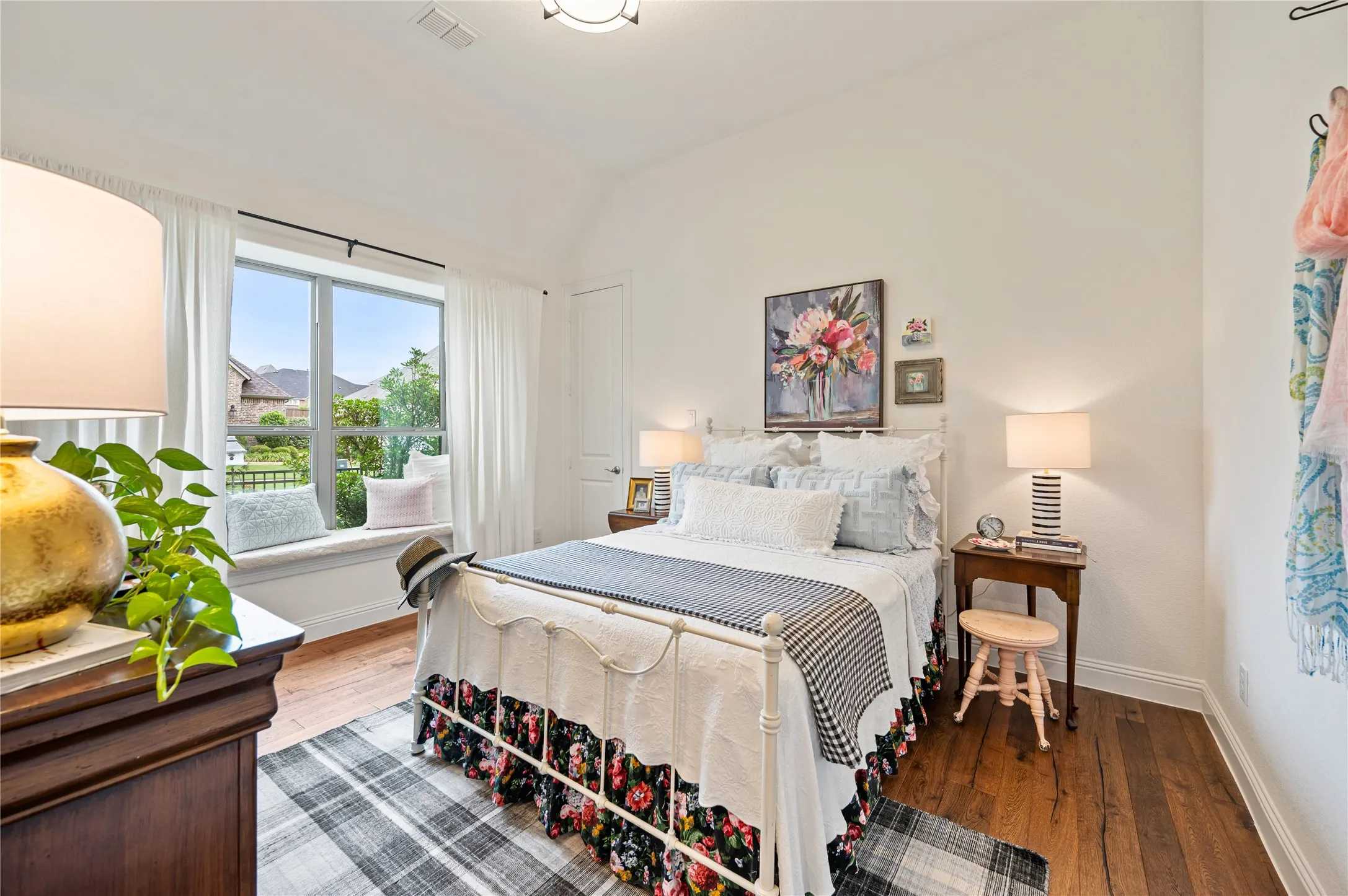 Additional bedroom with bench seating in window, walk in closet and natural light