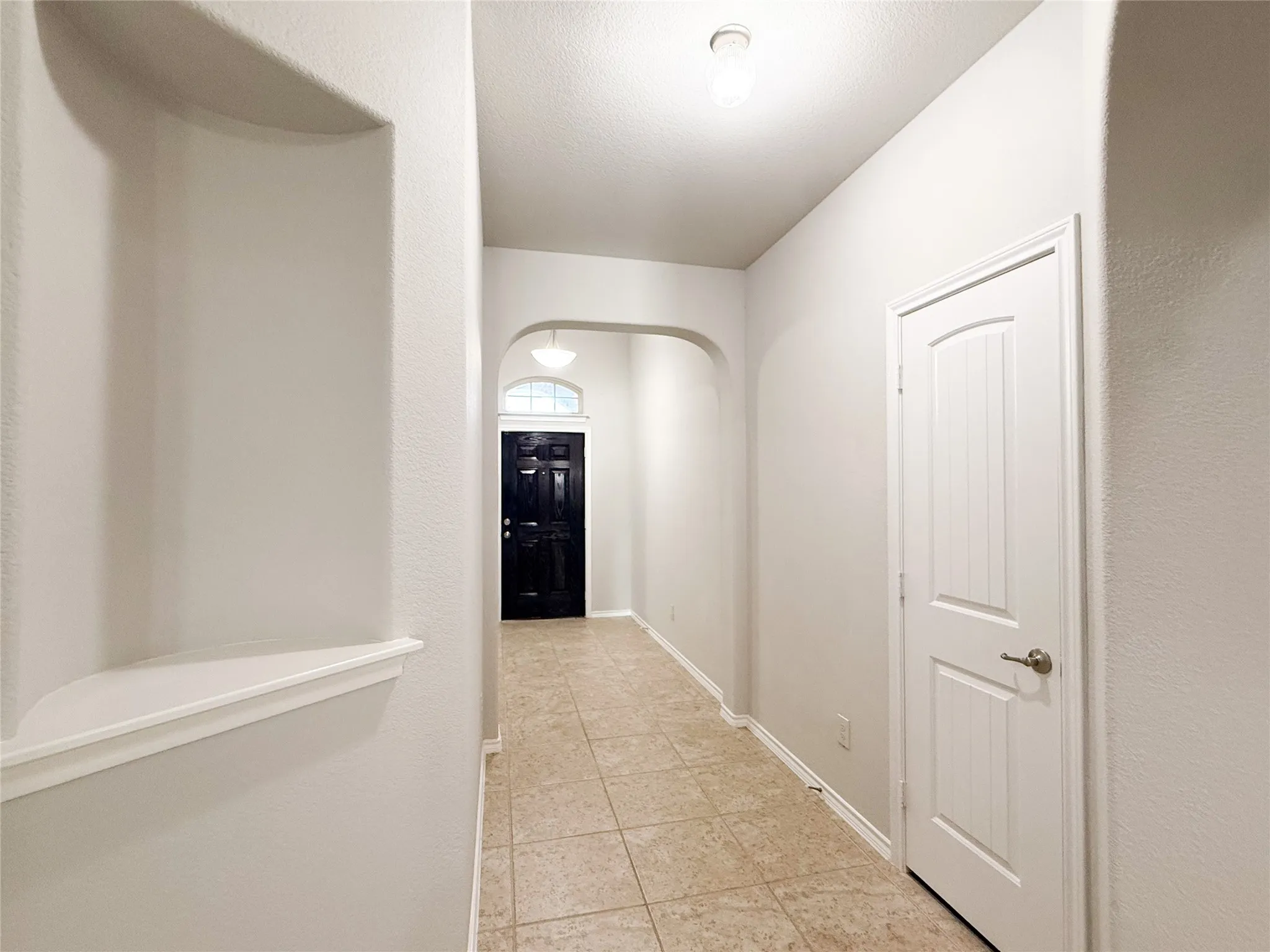 Entryway featuring ceramic tile flooring and light neutral wall finishes
