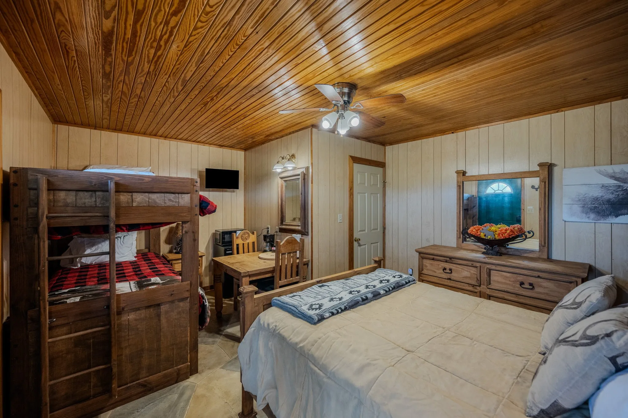 Wood-paneled ceiling with an overhead ceiling fan