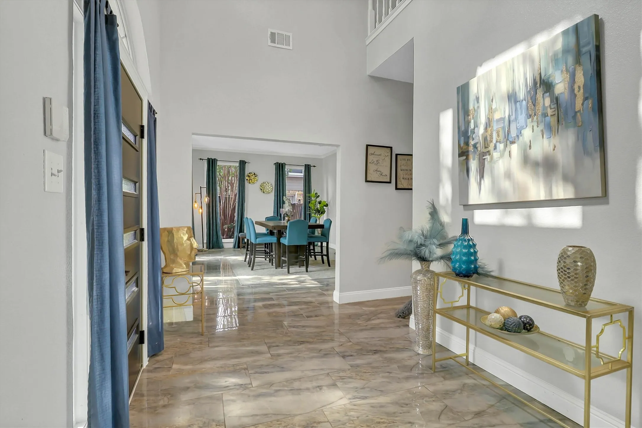 Spacious entry with high ceilings and wood-finish flooring