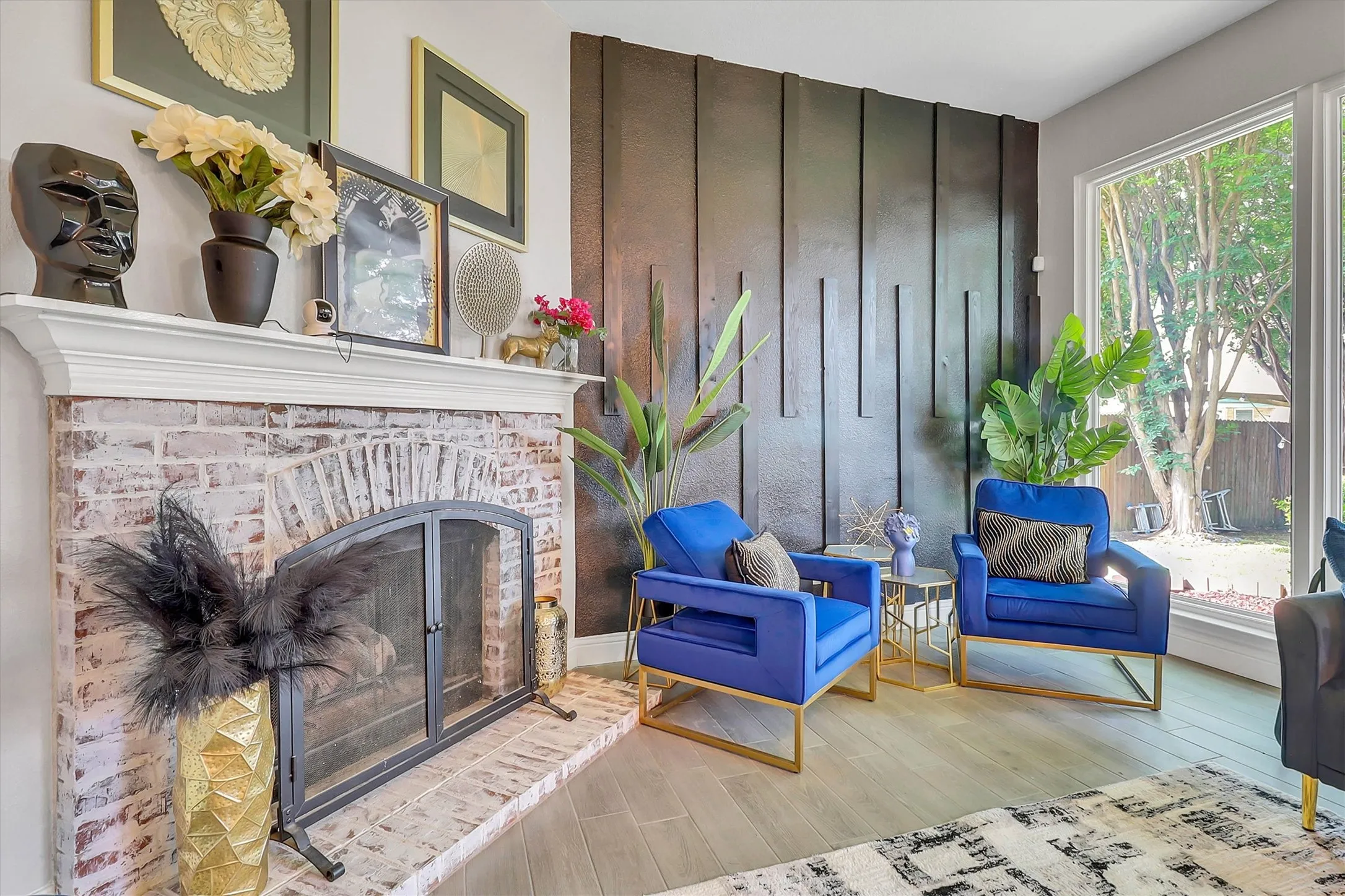 Whitewashed brick fireplace with a white mantel, complemented by a dark accent wall featuring vertical paneling