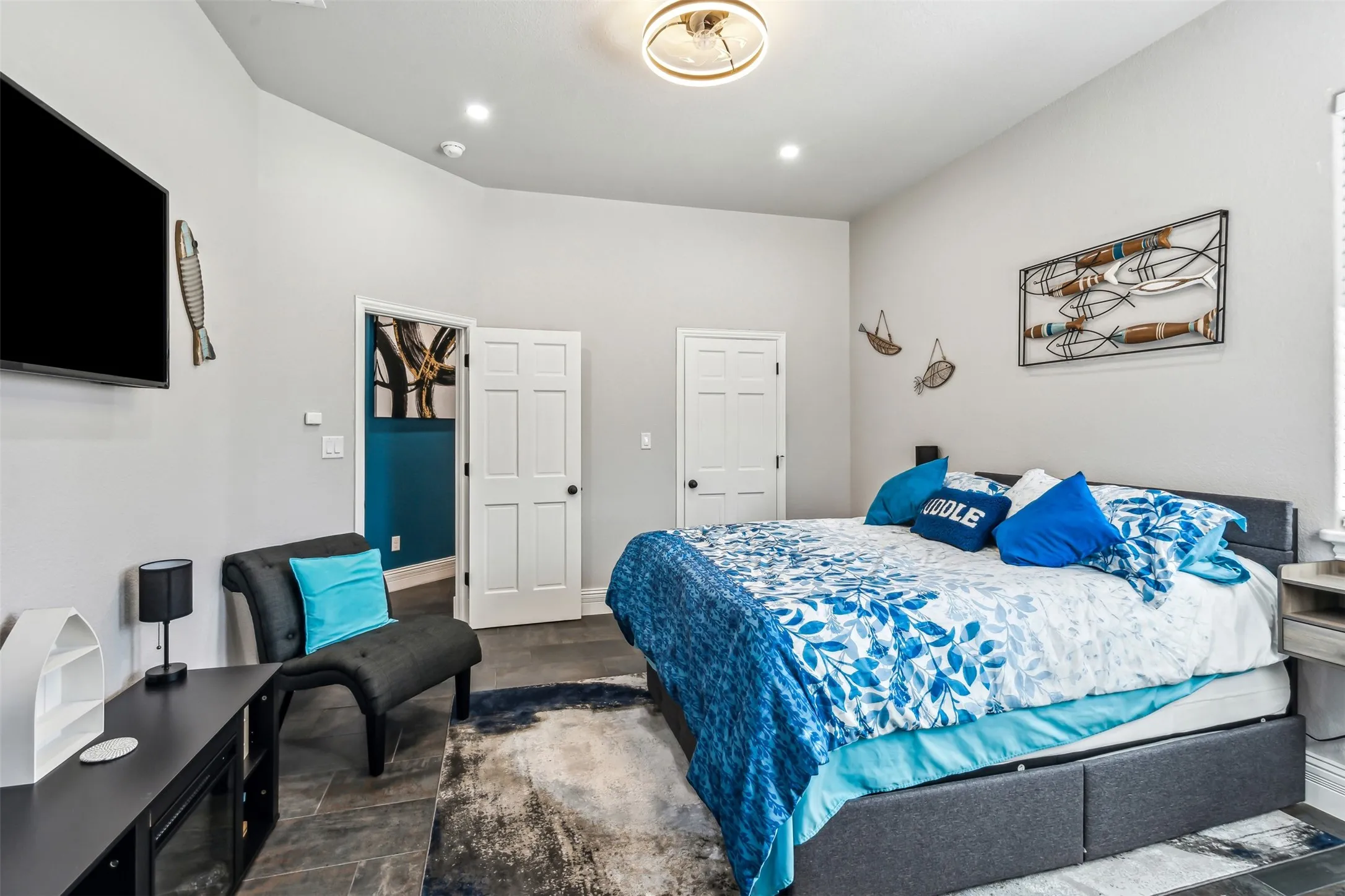 Spacious room featuring neutral painted walls, recessed lighting, and a contemporary ceiling fixture