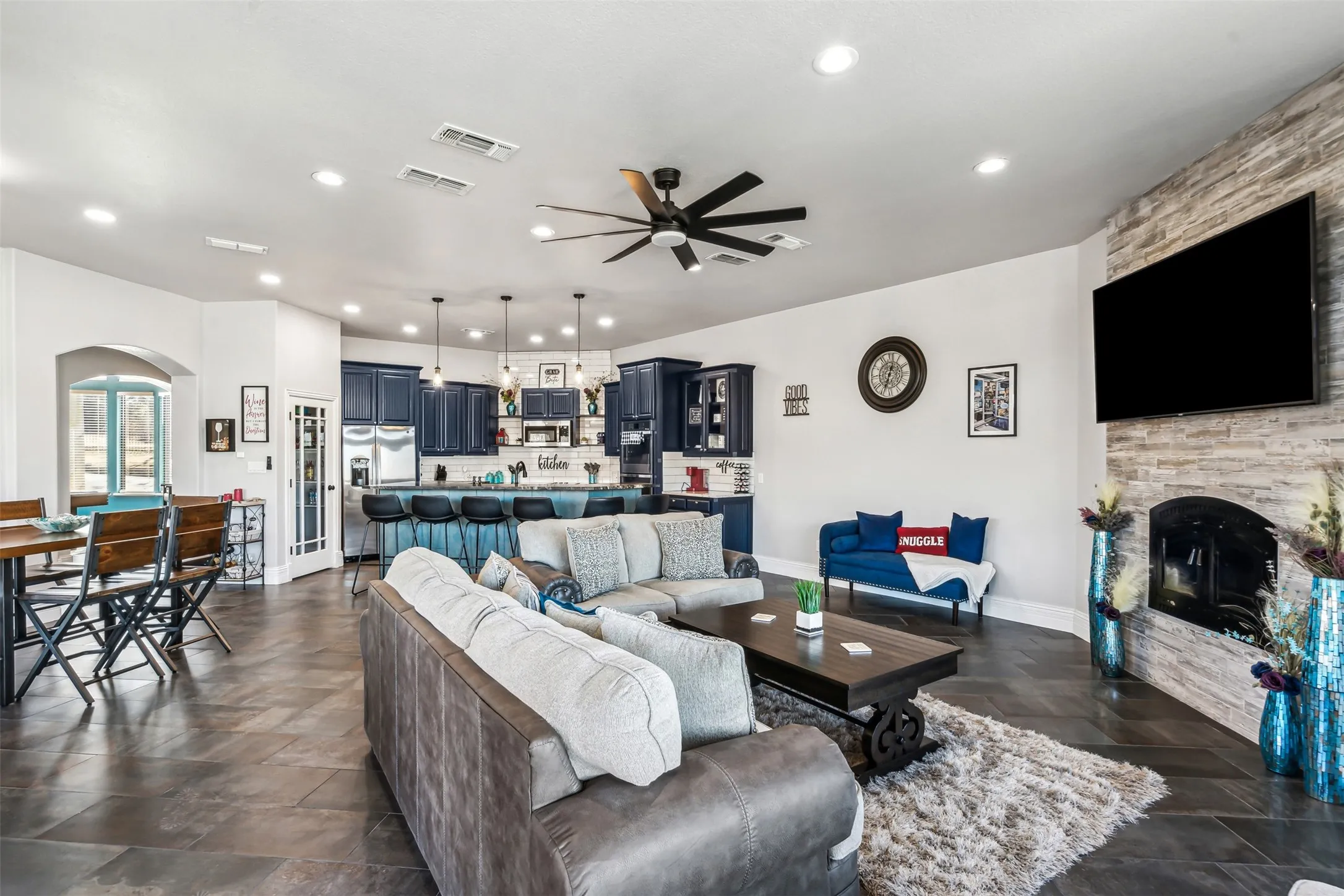 Open-concept living space featuring expansive tile flooring and recessed lighting