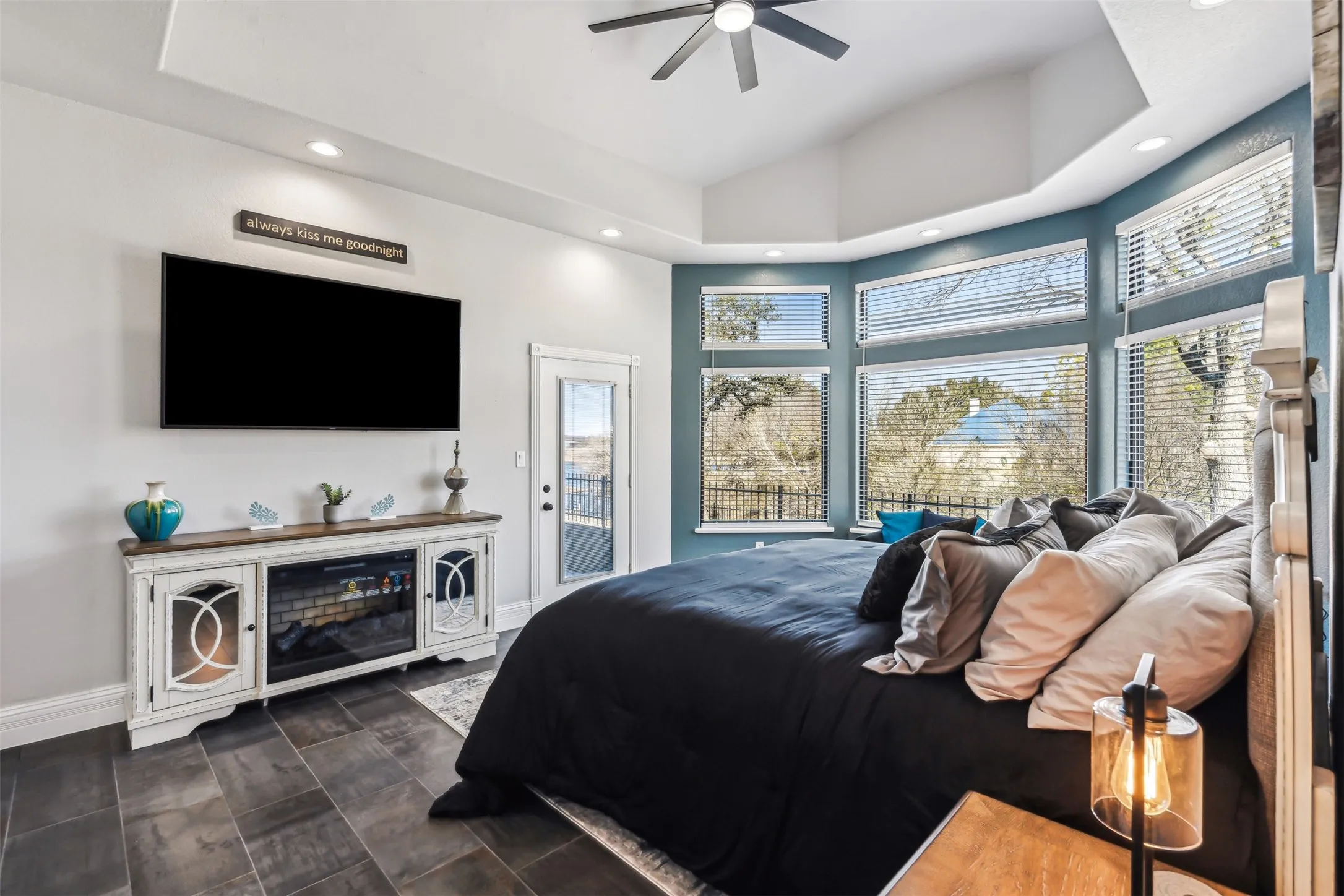 Spacious room featuring vaulted ceilings, recessed lighting, and dark tile flooring
