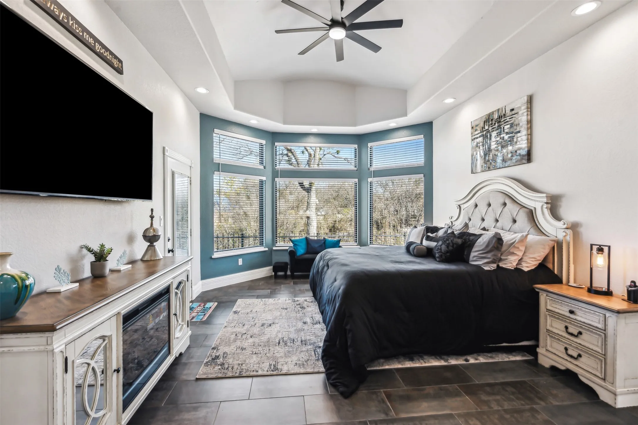 Spacious room featuring dark tile flooring, a vaulted ceiling, and recessed lighting