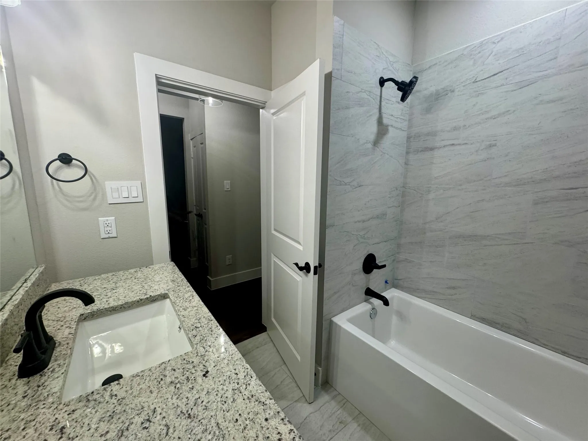 Bathroom featuring vanity and shower / bathtub combination