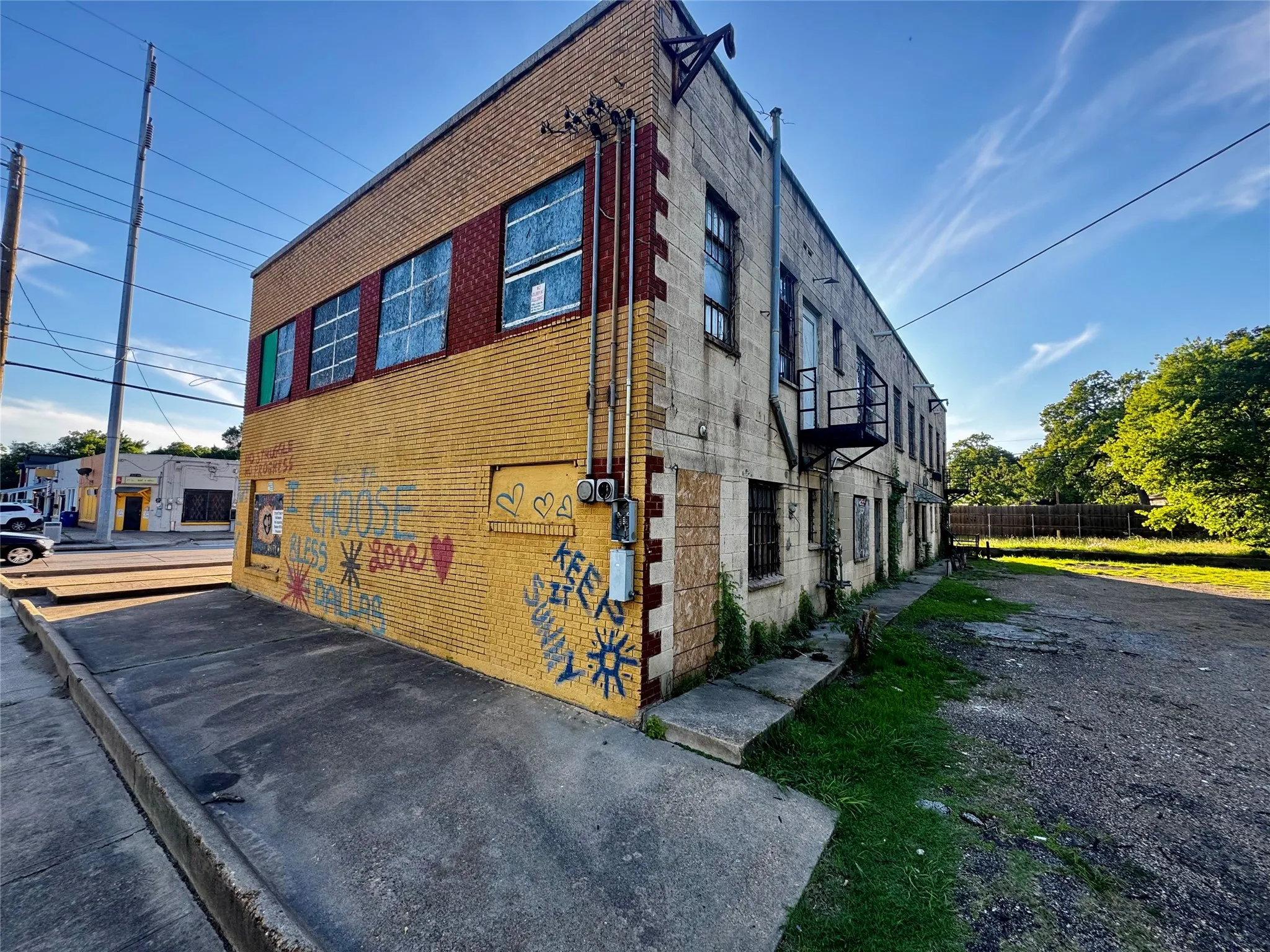 Two-story commercial building featuring brick and stone exterior construction (Exterior wording part of a volunteer community beautification of empty spaces.)