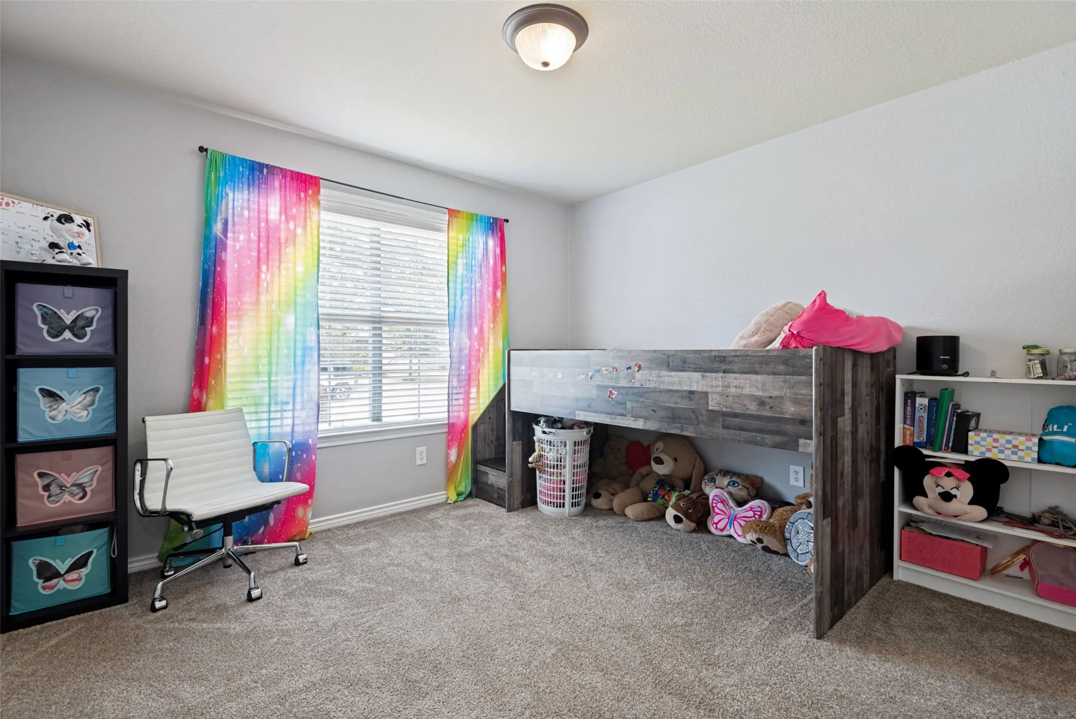 Spacious room featuring neutral carpeting, a large window with horizontal blinds, and a flush-mount ceiling light