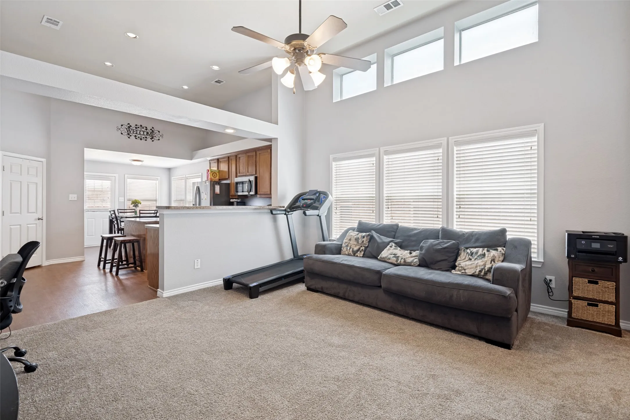 Open concept living area featuring high ceilings and transom windows