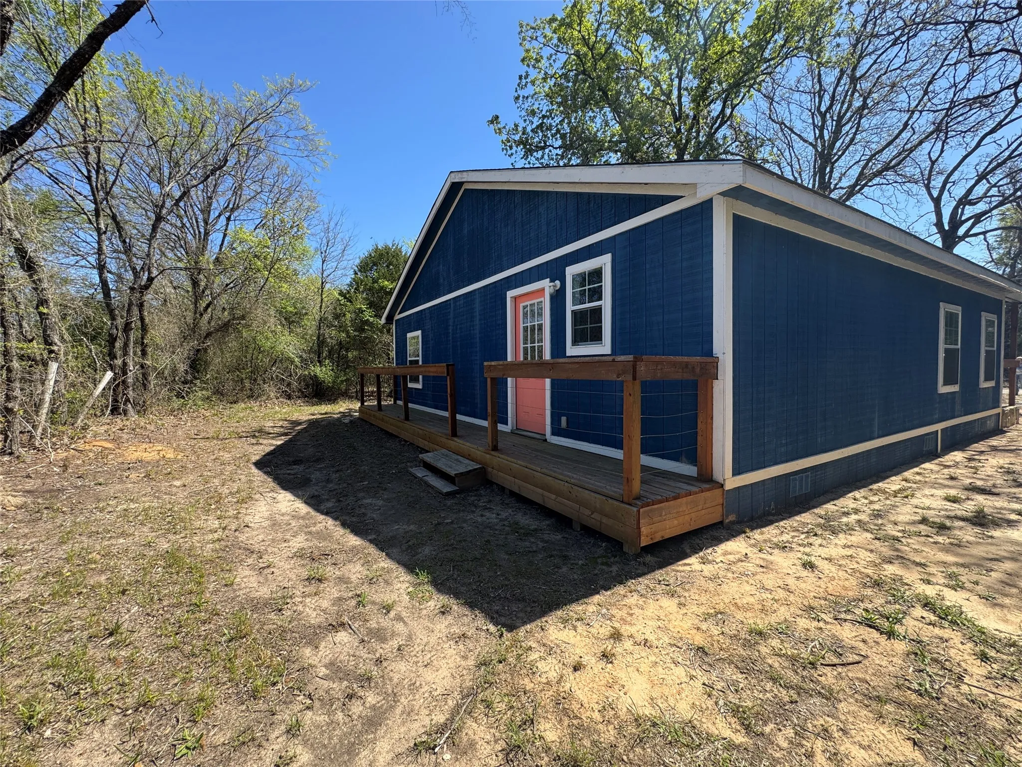 Single-story residence featuring blue vertical siding with white trim