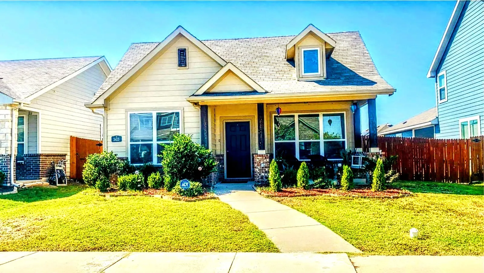 View of front of house with a front lawn, extended porch with swinging bench