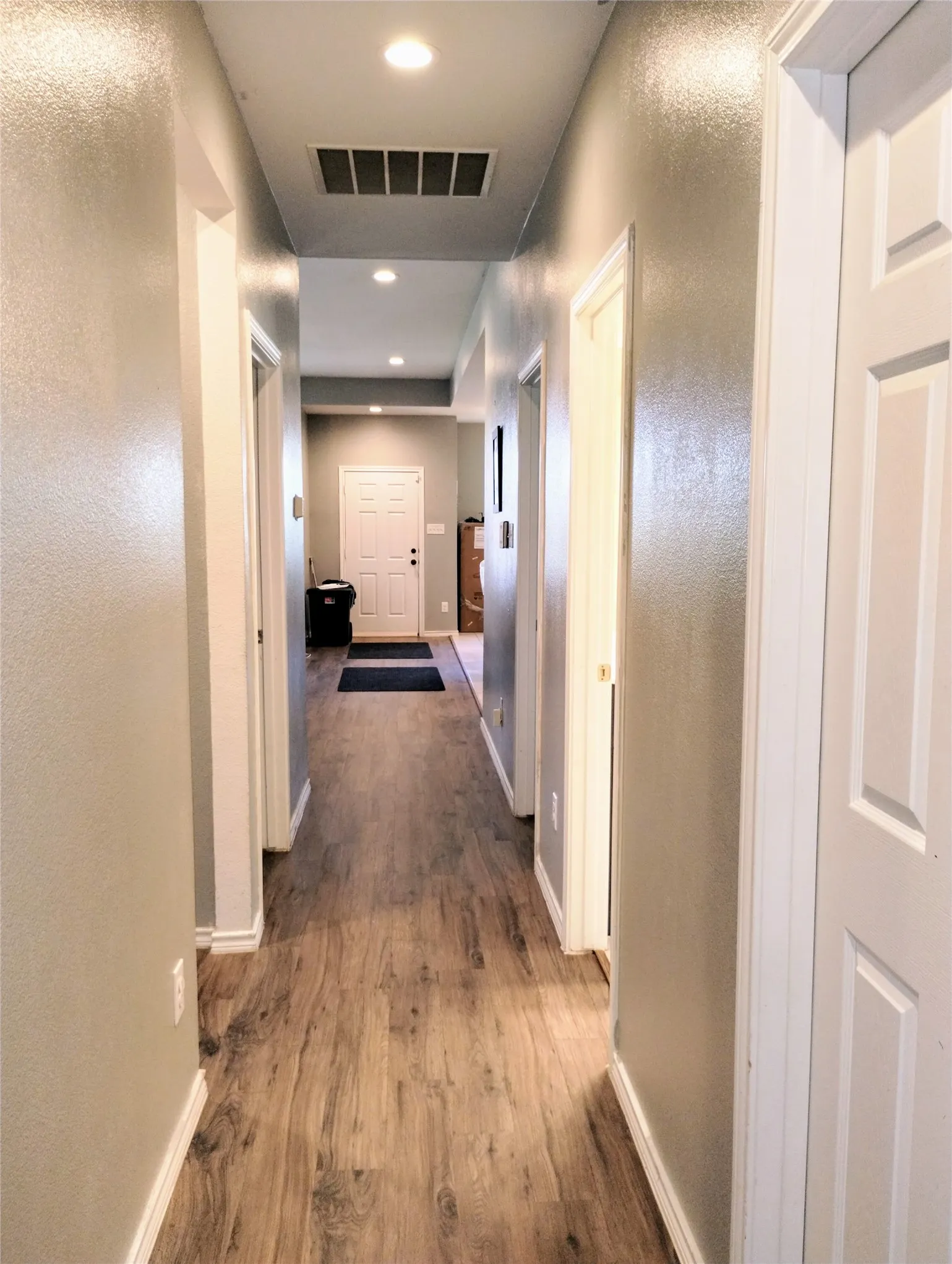 Hall featuring dark wood-type flooring