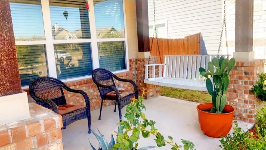 View of patio with swing bench