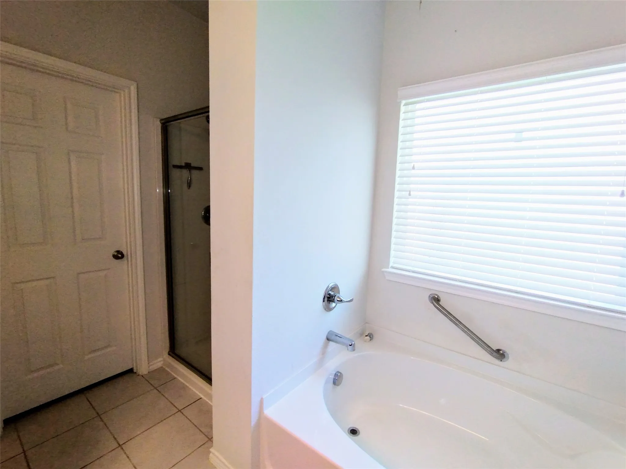 Bathroom featuring plus walk in shower and tile patterned floors
