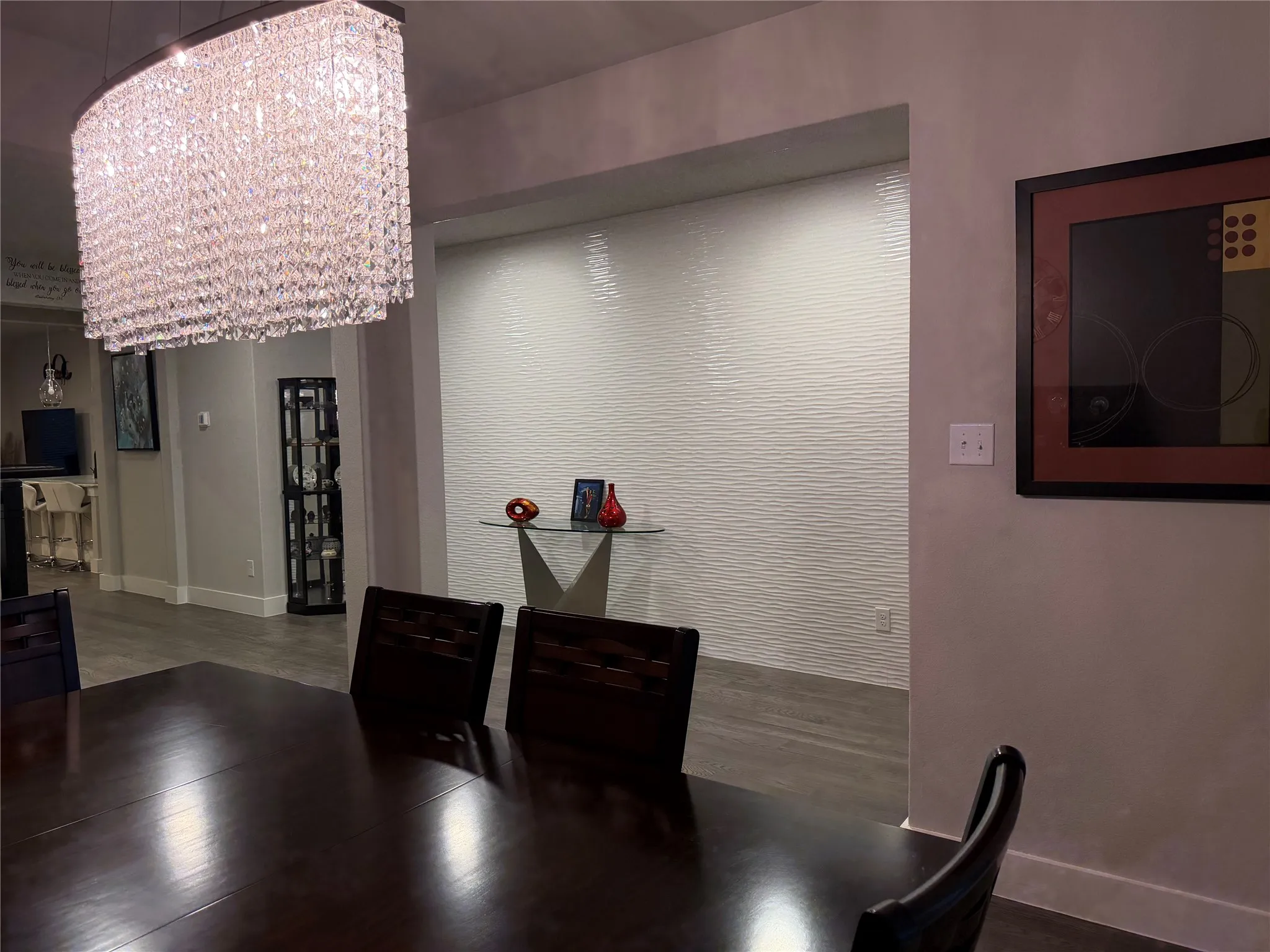 Spectacular Tiled Wall in Entry Is a Gorgeous Focal Point to Dining. Unique Modern Light Fixtures Throughout