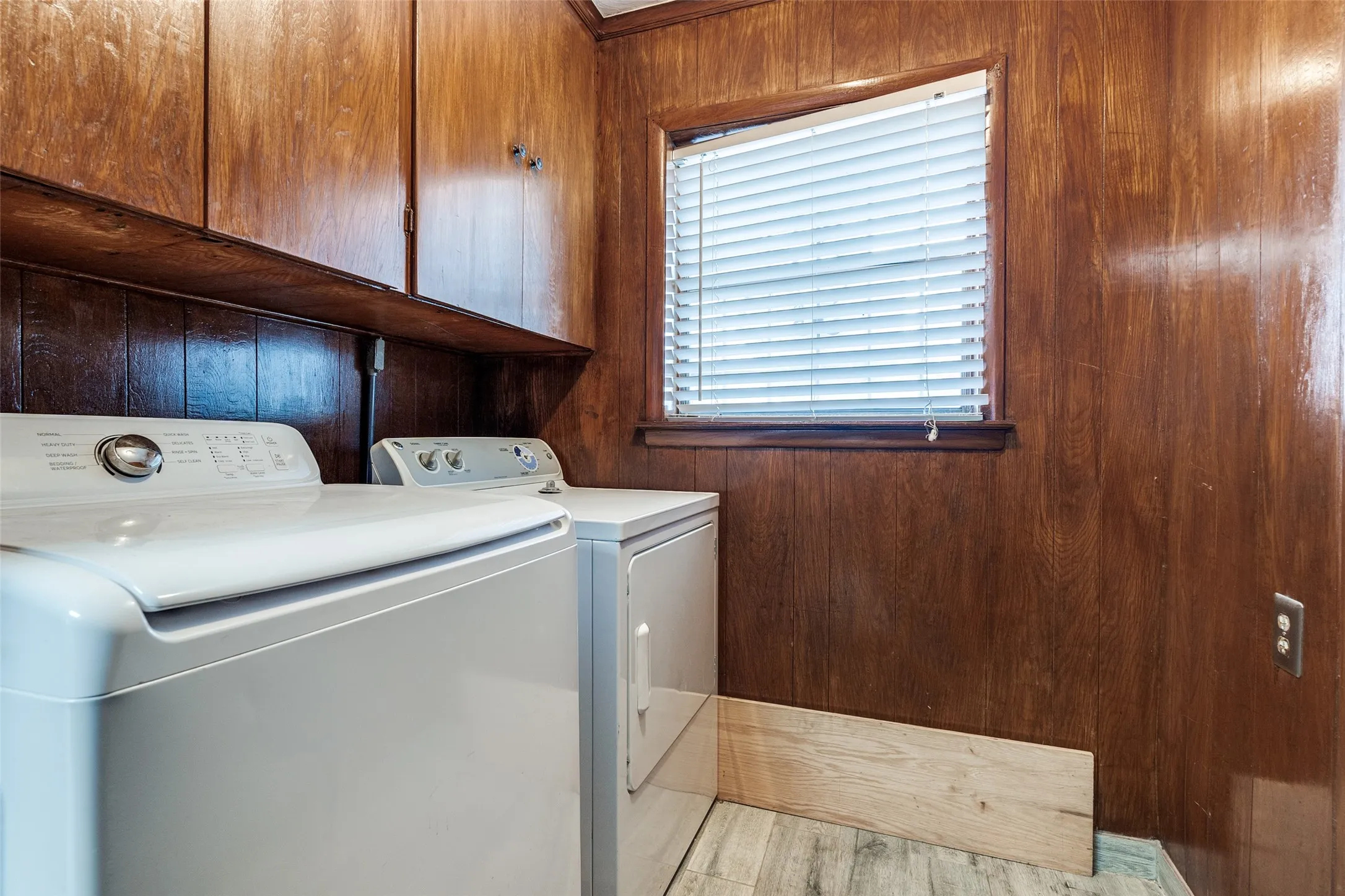 Dedicated laundry area featuring a white washing machine and dryer