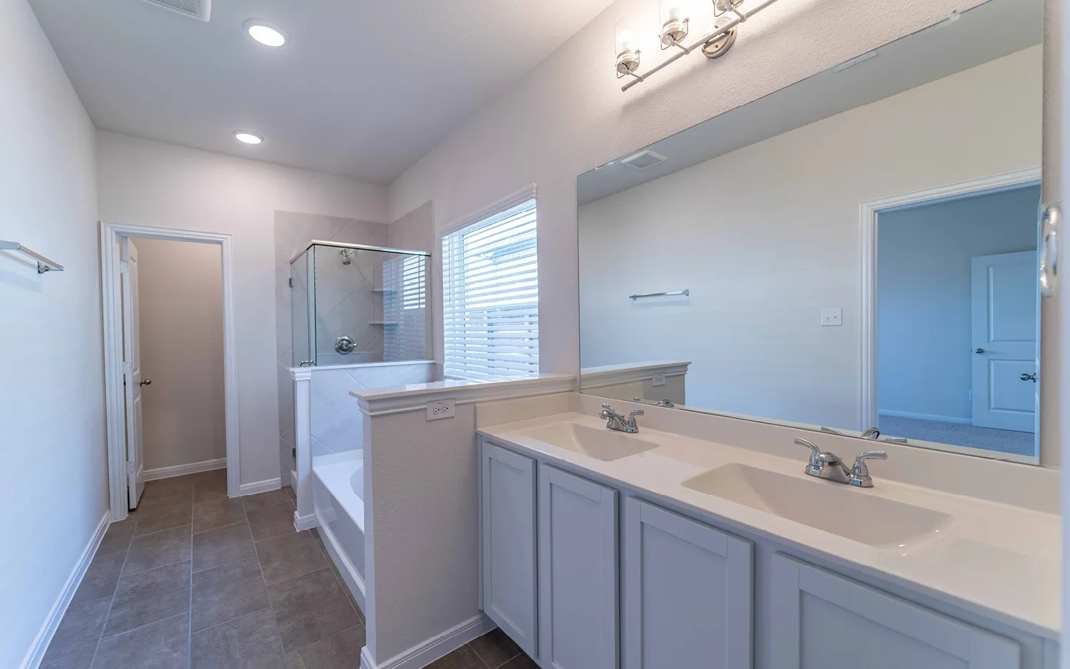 Dual vanity with integrated sinks and white cabinetry