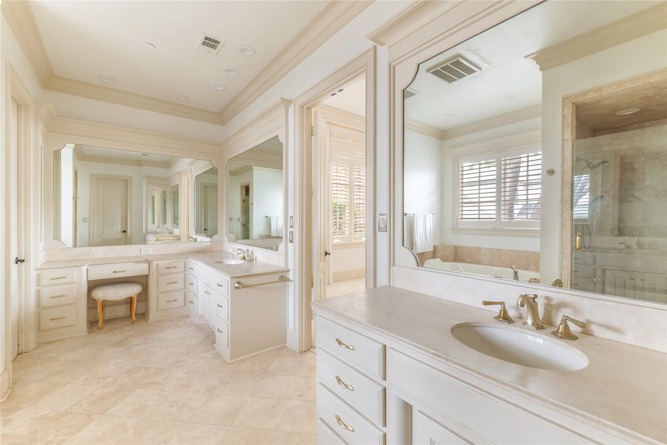 Dual vanity stations featuring extensive countertop space, integrated sinks, and polished brass fixtures