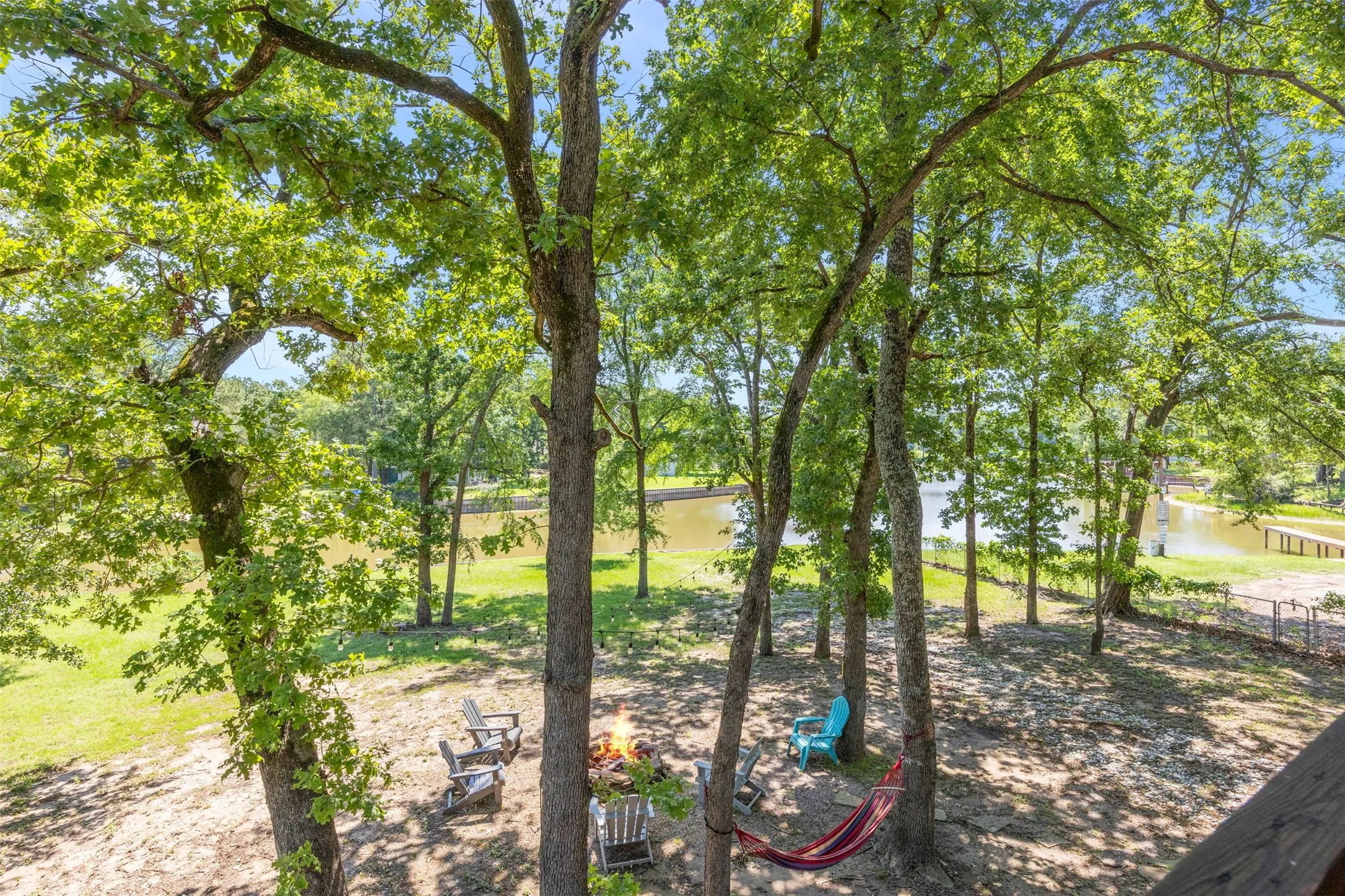 Expansive backyard retreat featuring mature trees and waterfront access