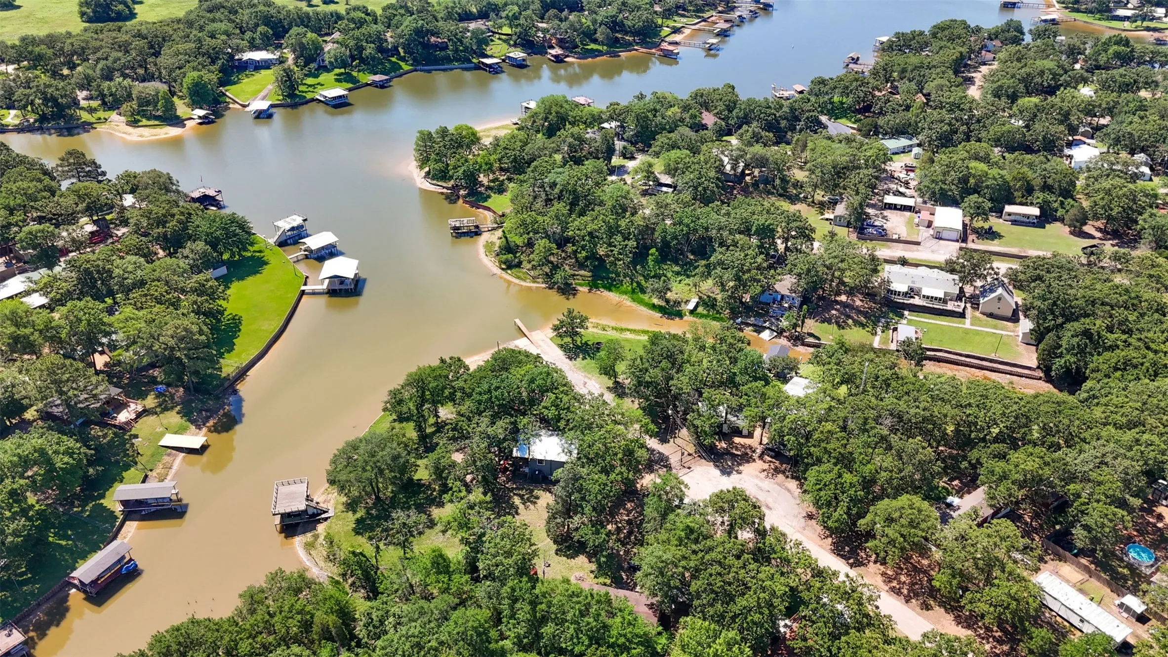 Aerial perspective showcasing a waterfront community with numerous properties featuring private boat docks