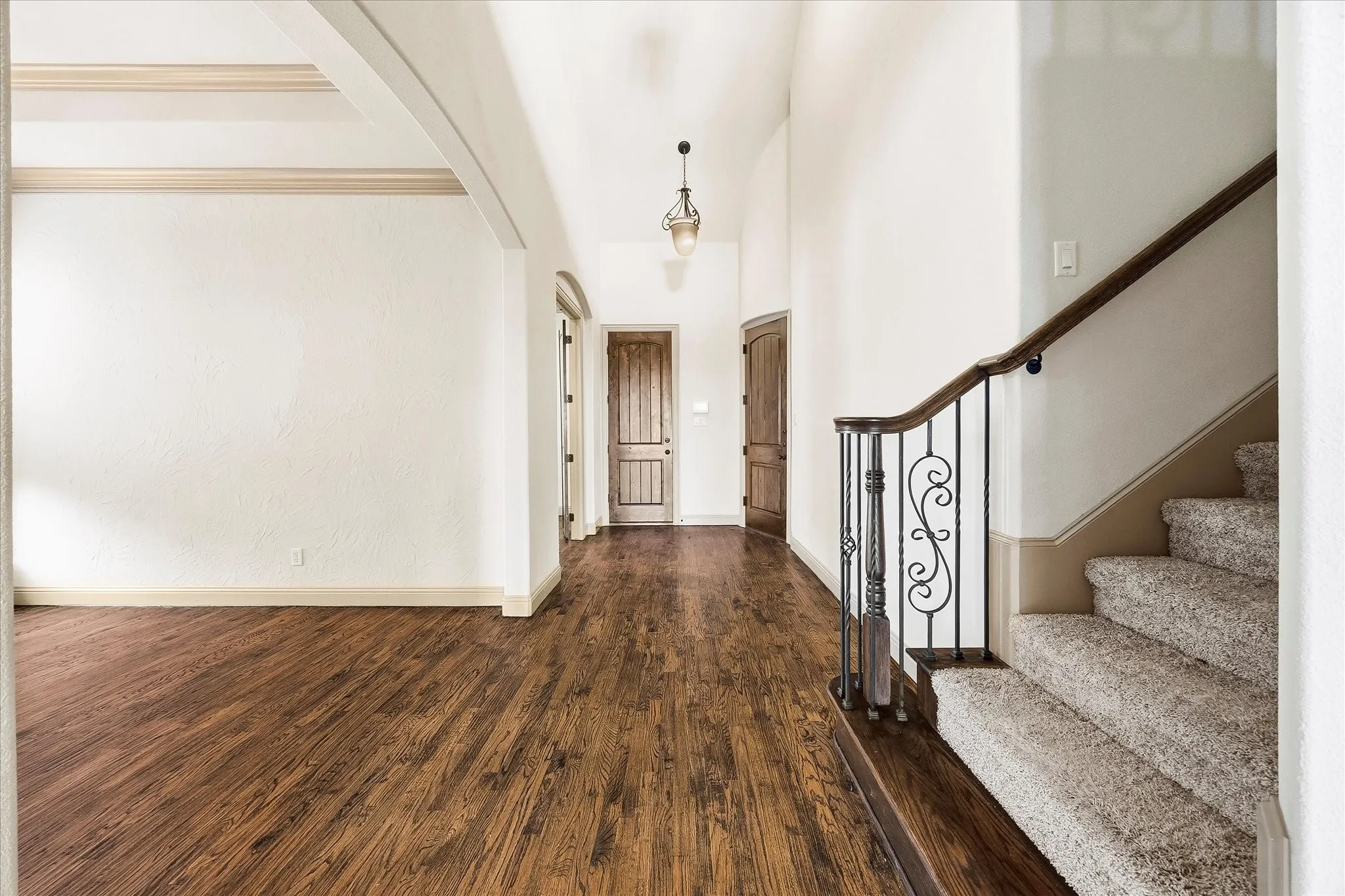 Majestic staircase opens onto dining area and entry